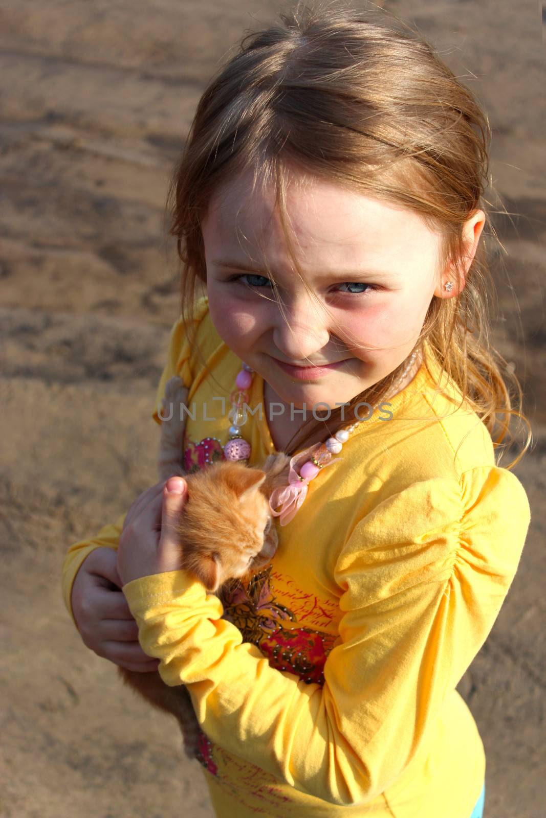 image of little girl with little red kitten