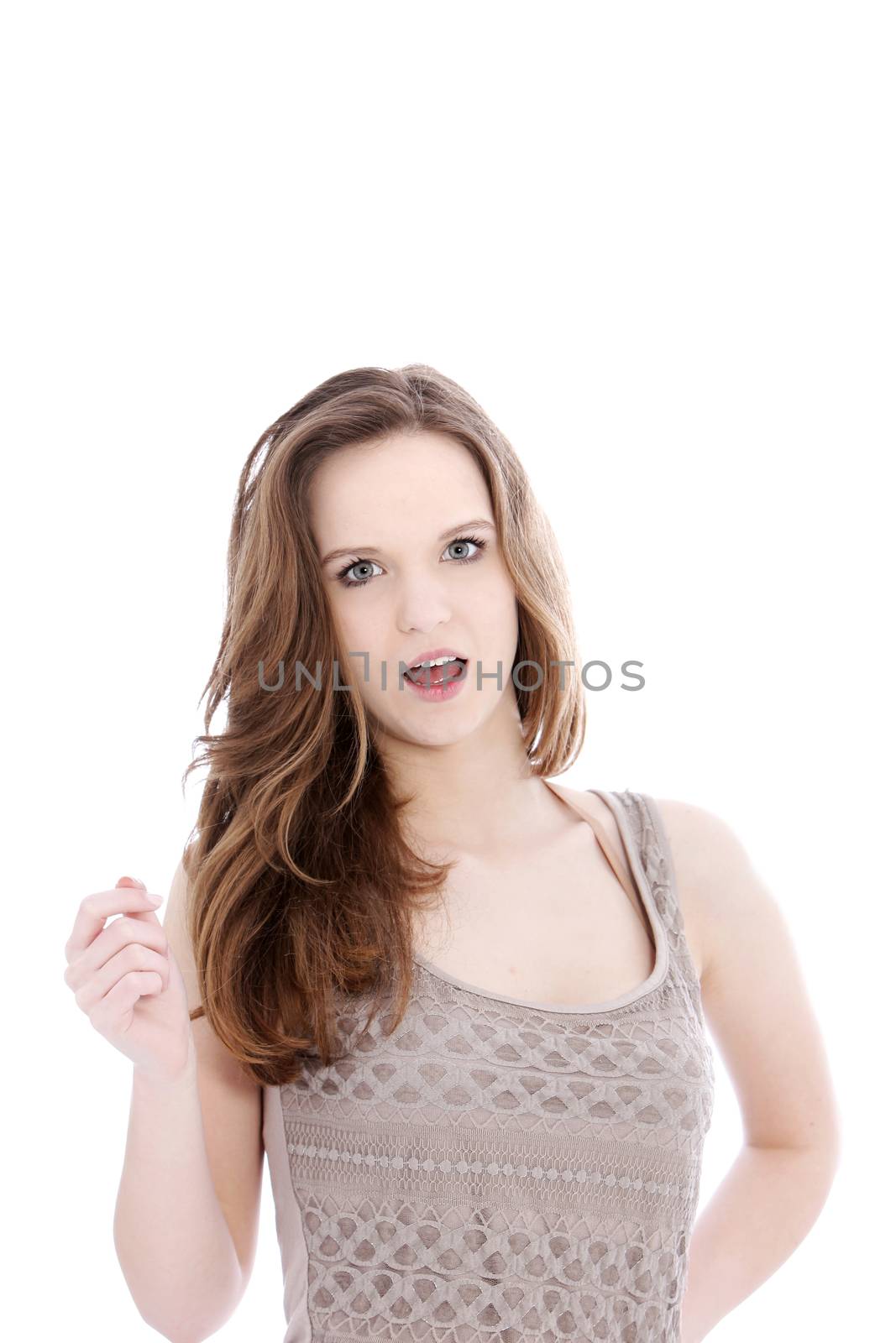 Attractive young woman standing clicking her fingers looking at the camera with her mouth open isolated on white