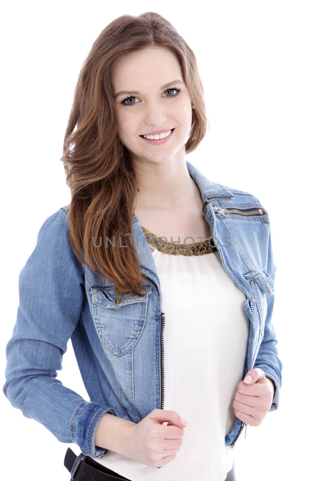 Smiling teenage woman in a trendy denim jacket looking at the camera, upper body studio portrait on white