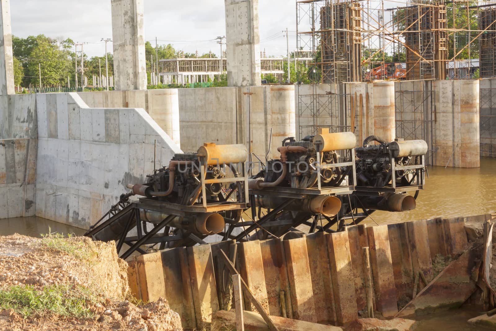 Water pumps stanby at dam construction site.