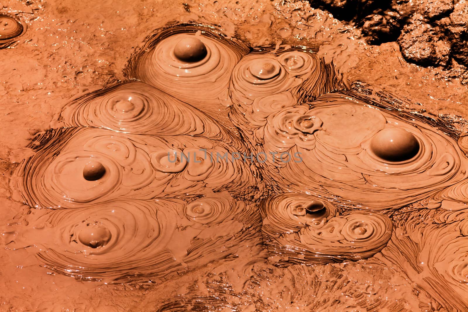Background texture pattern of bubbling hot mud that boils up due to geothermal volcanic geyser activity