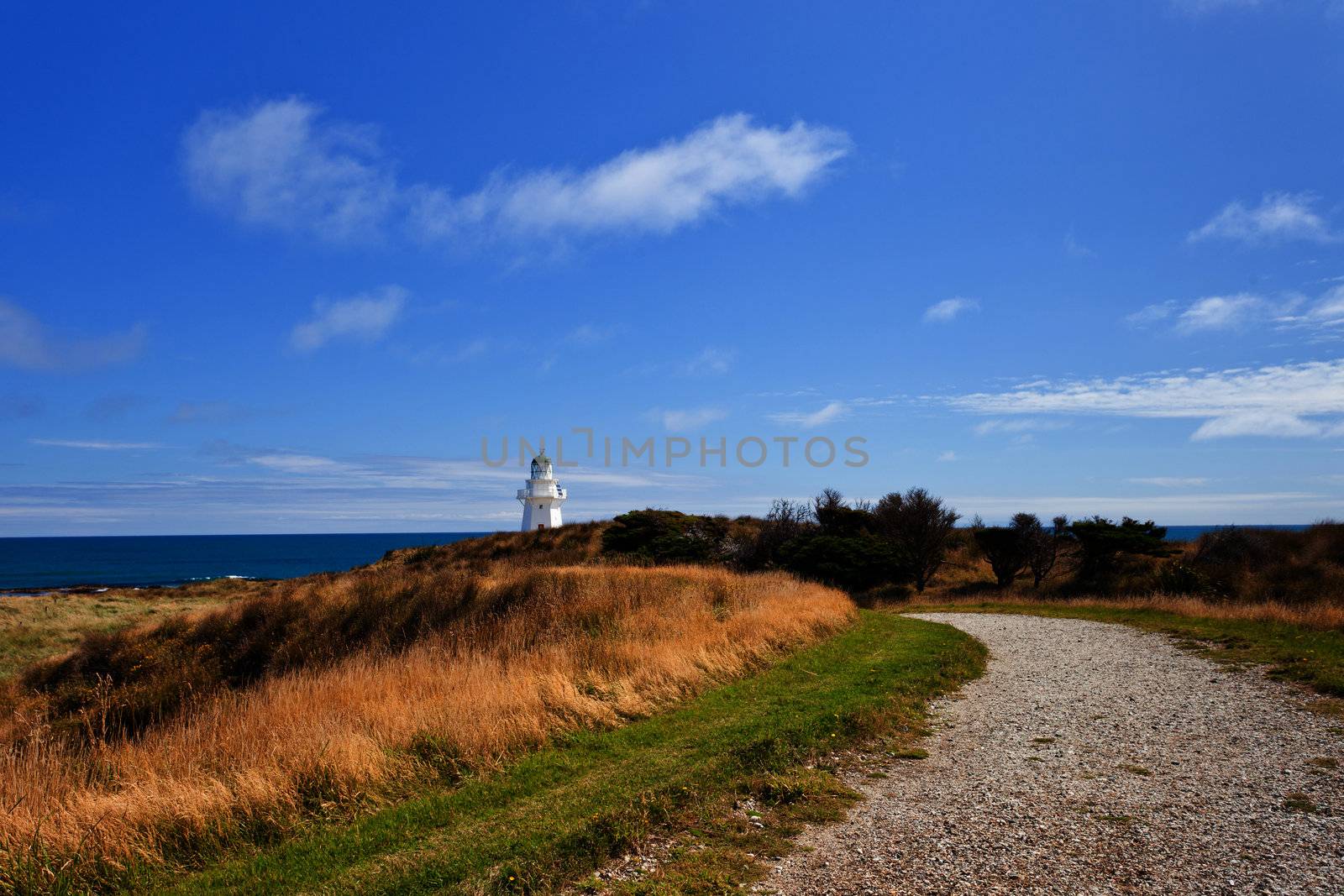 Path leading to beautifully restored heritage building of Waipapa Point Lighthouse on The Catlins coast on South Island of New Zealand