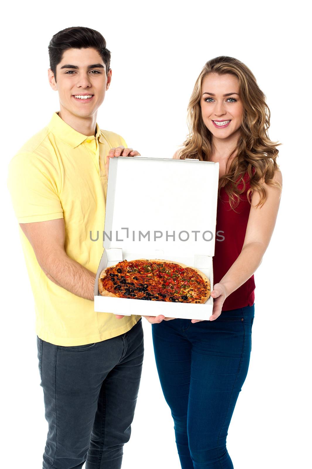 Young couple offering a medium sized delicious pizza
