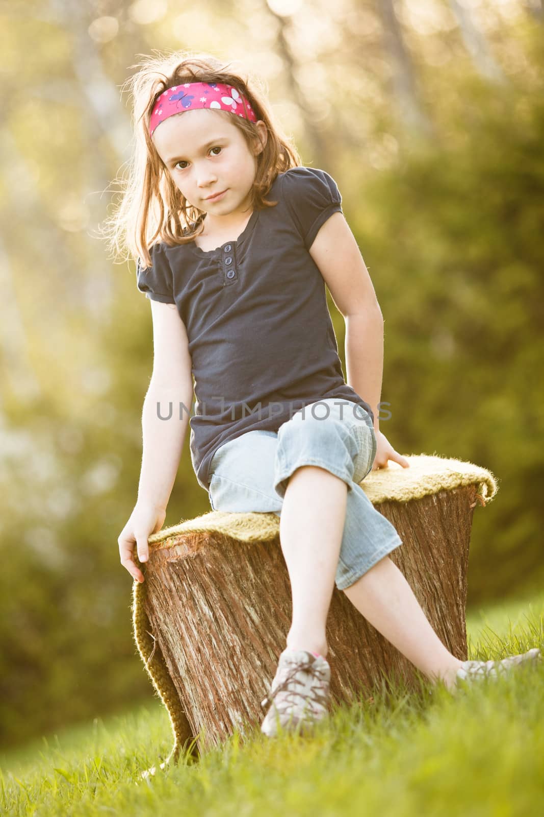 Girl sitting on a tree trunk by Talanis