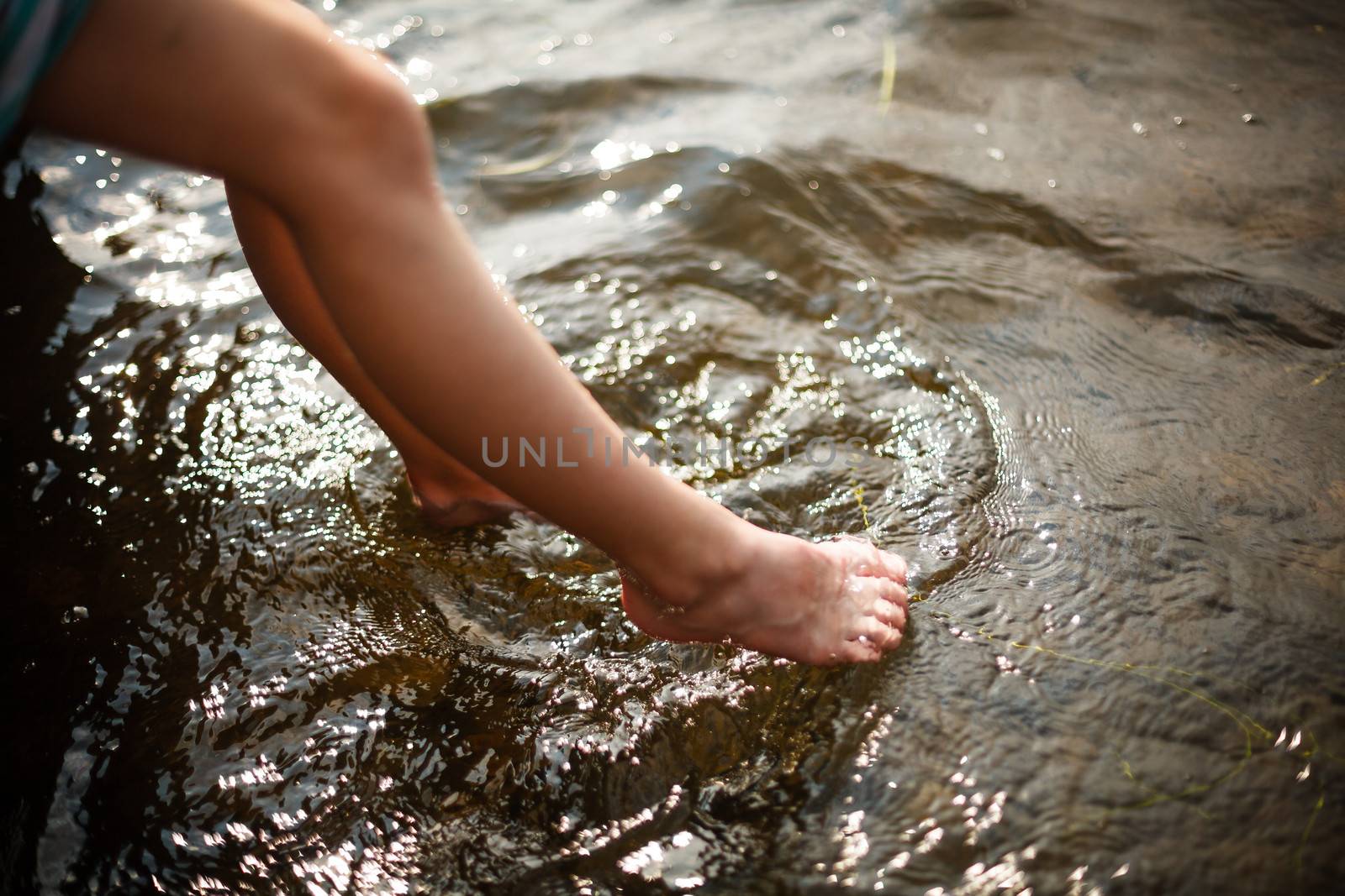 Toes dipping in water on a warm summer day