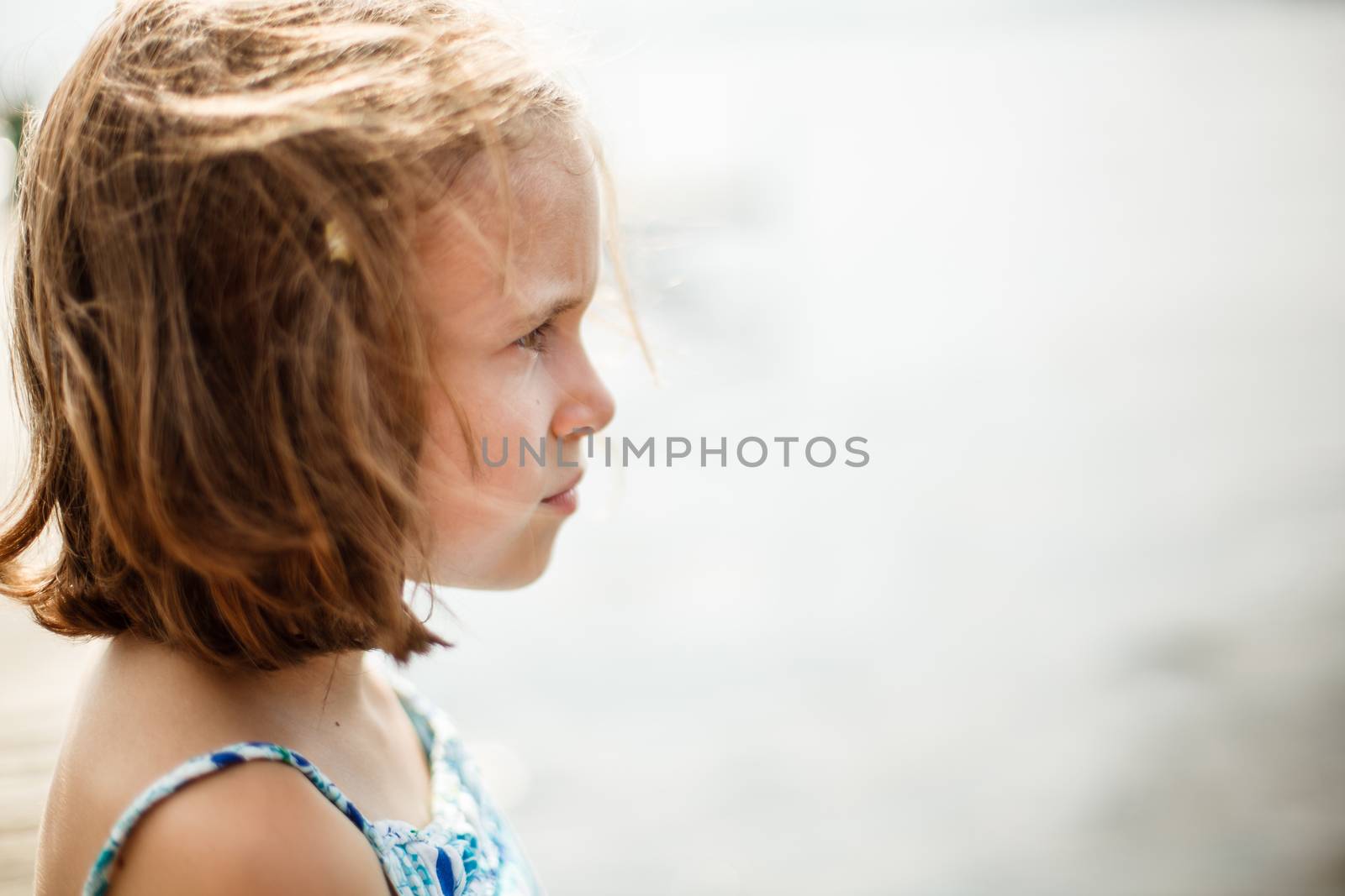 Thoughtful girl on a warm and windy summer day