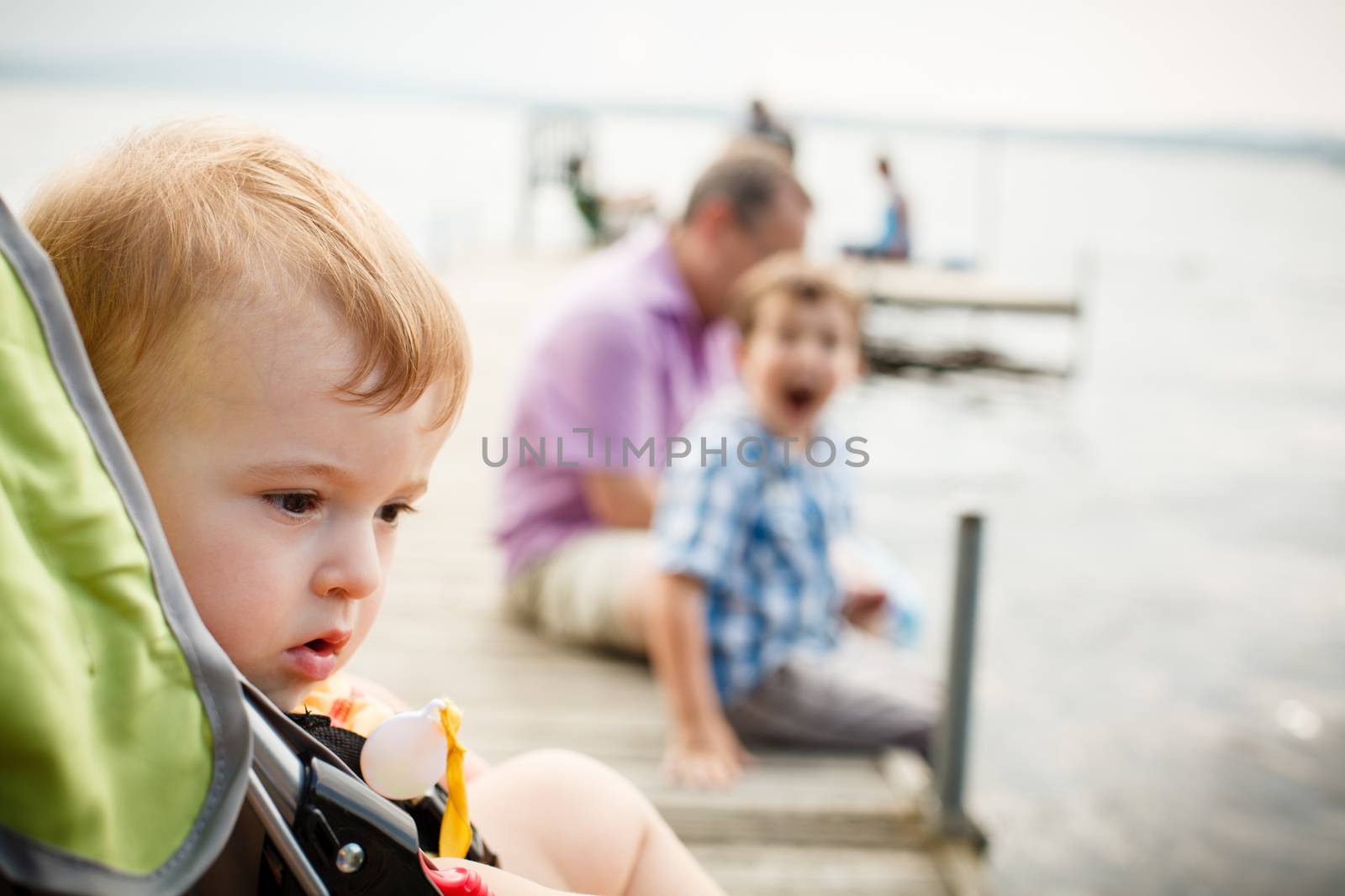 Baby in a stroller by a wharf