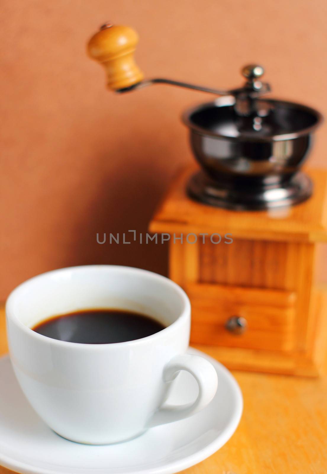 Cup of hot coffee with coffee grinder and beans  by nuchylee