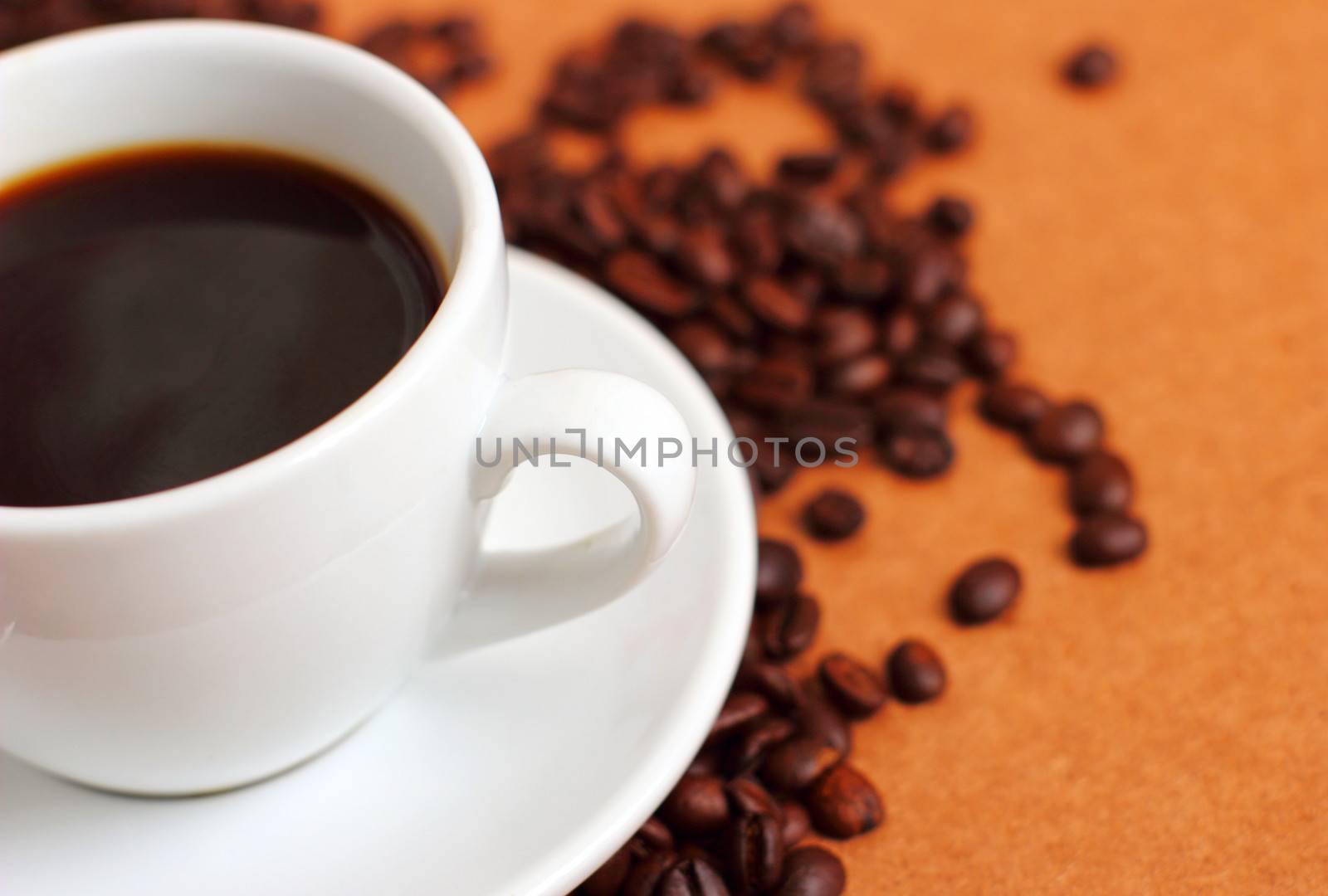 White cup of coffee on coffee beans by nuchylee