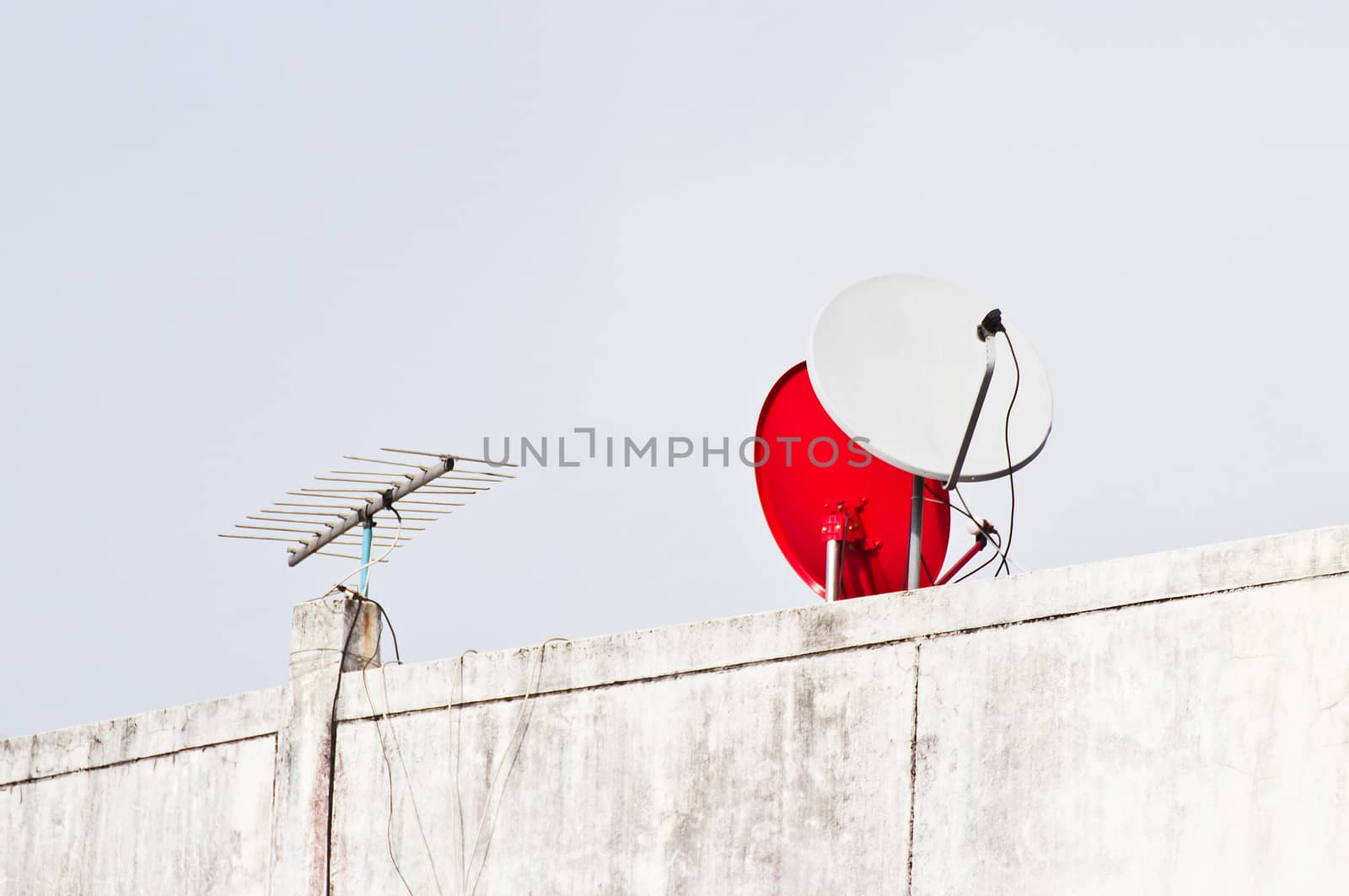 Satellite dish antenna over blue sky background