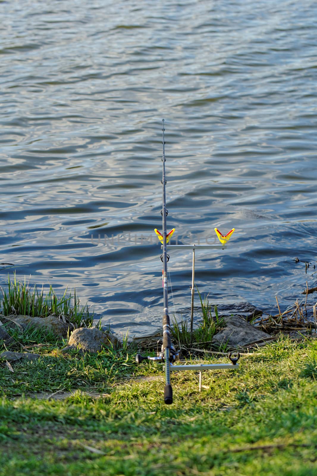 fishing rod on rack by the lake
