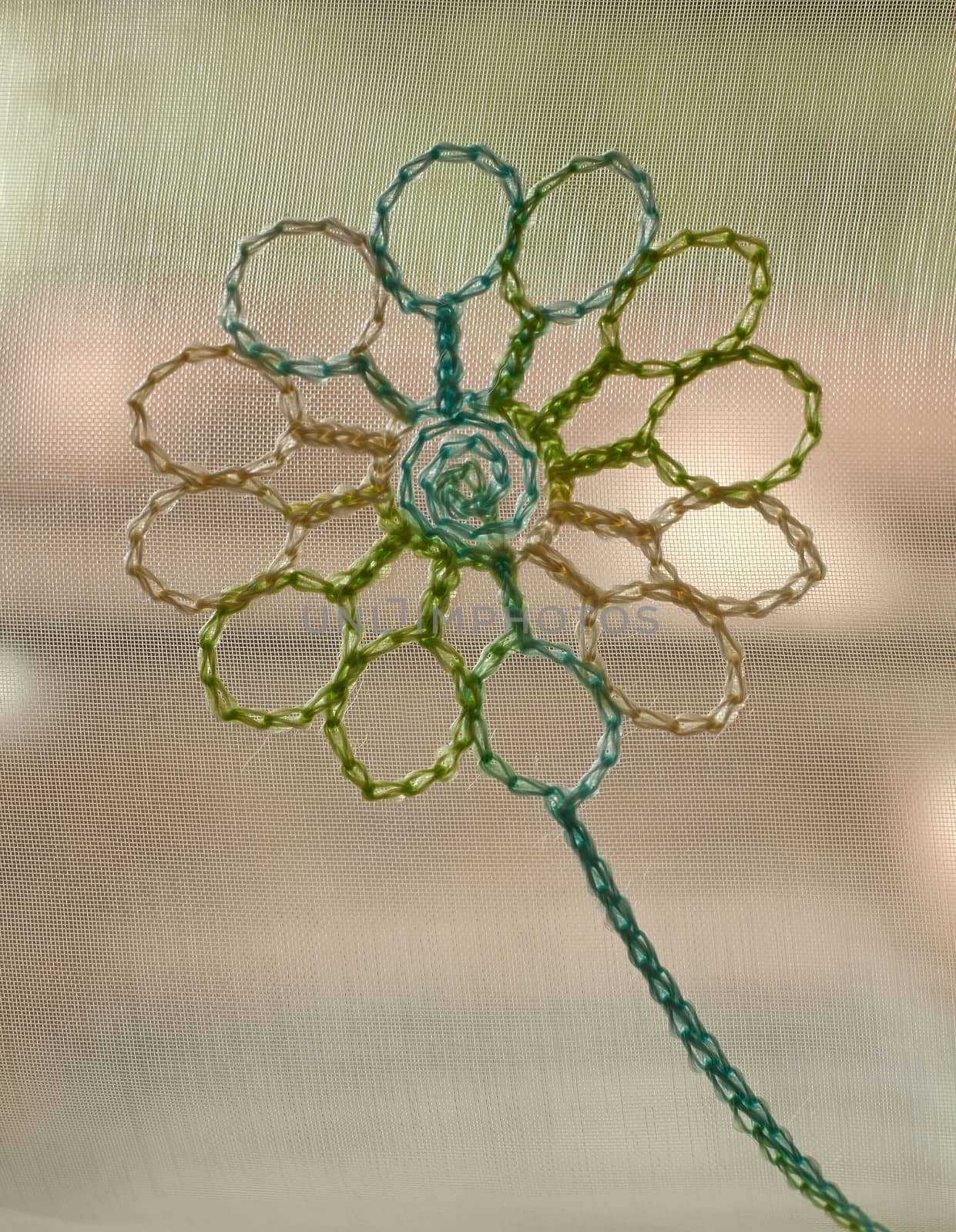 Background from multi-colored braiding with a flower in the center