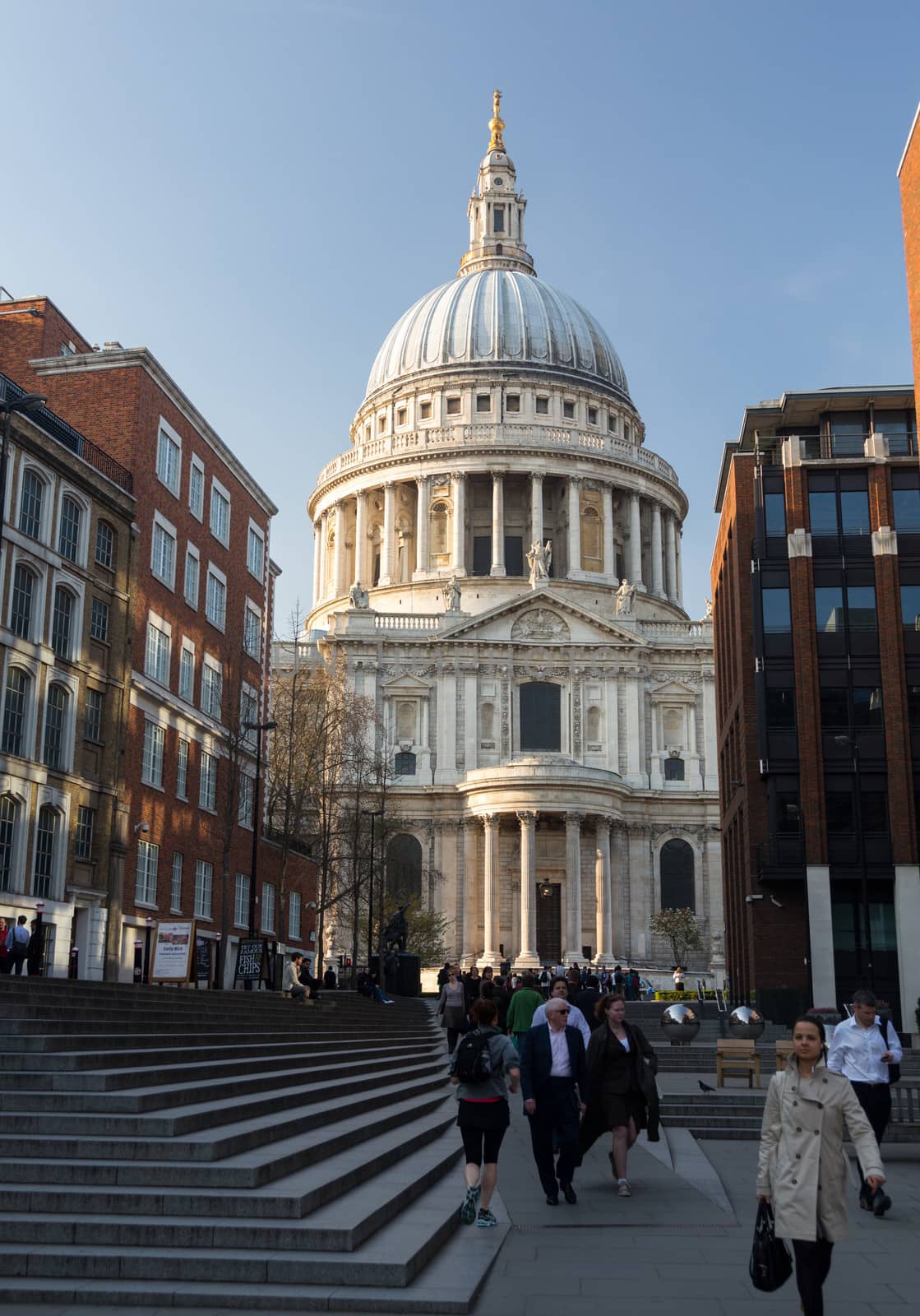 LONDON, UK - 23 APRIL: Londoners walk home from St Pauls cathedral area of London on 23 April 2013. The dome at 365 feet high towers over Sermon Lane.