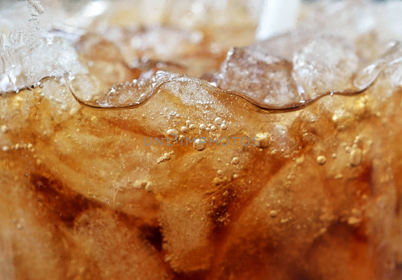 Ice cubes with cola close up