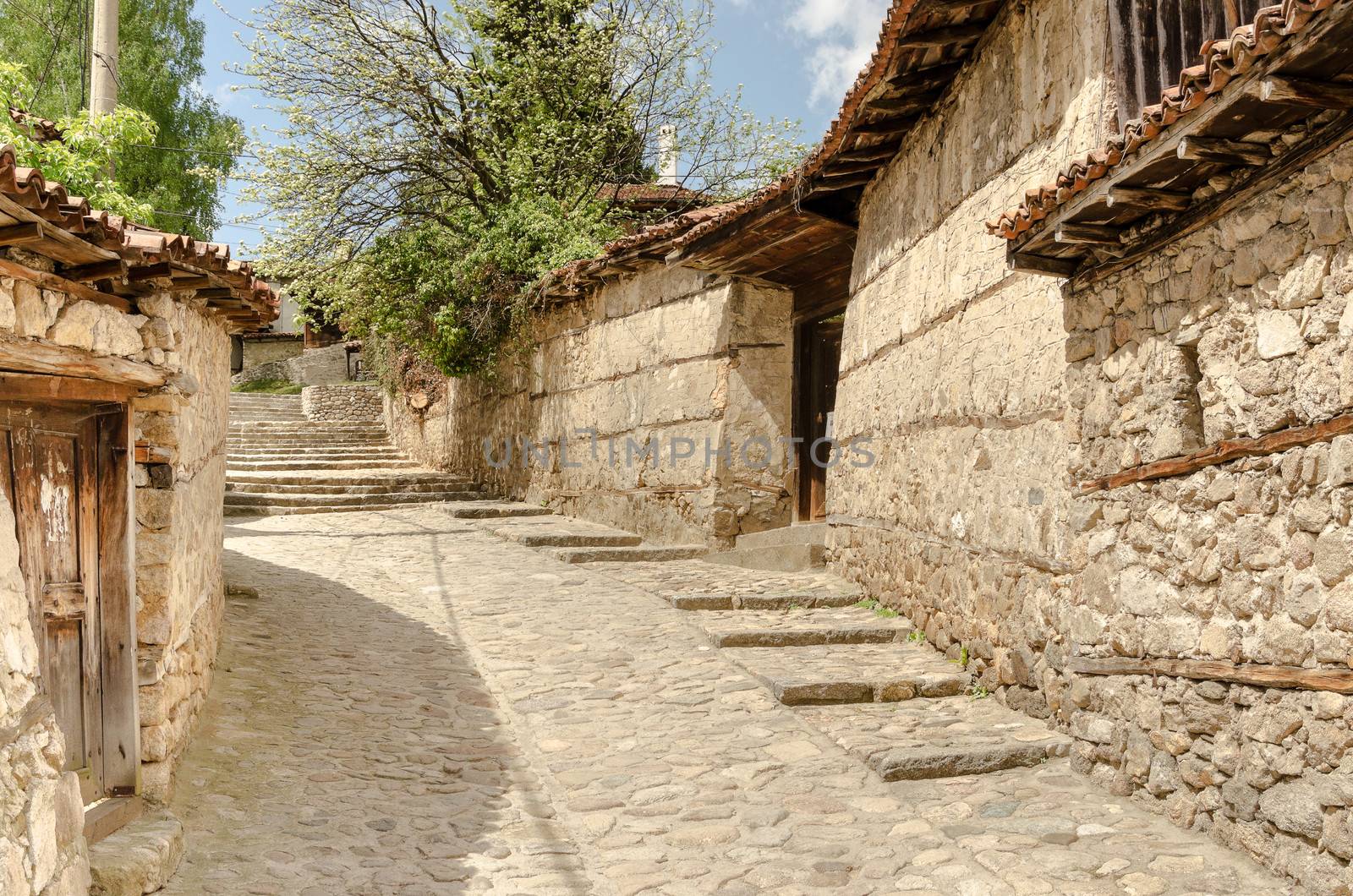 A traditional old street in Koprivshtitsa Bulgaria, from the tim by velislava