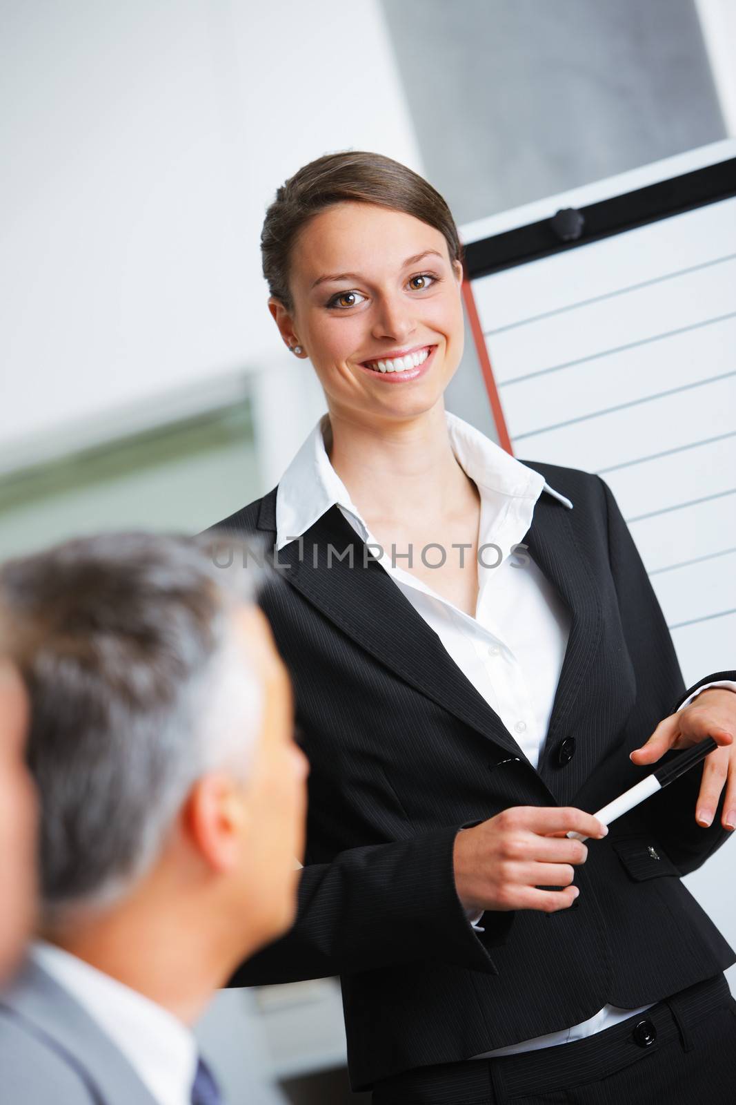 Portrait of a smiling businesswoman giving a presentation at work