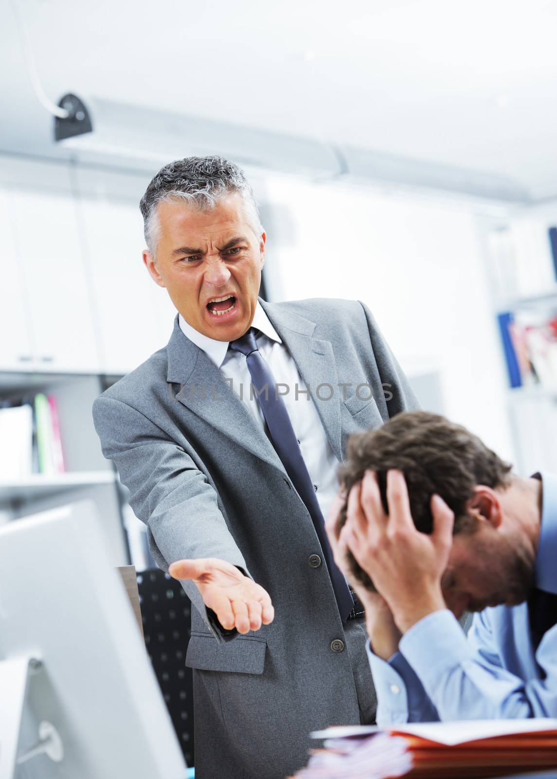 Mature manager shouting at his office worker