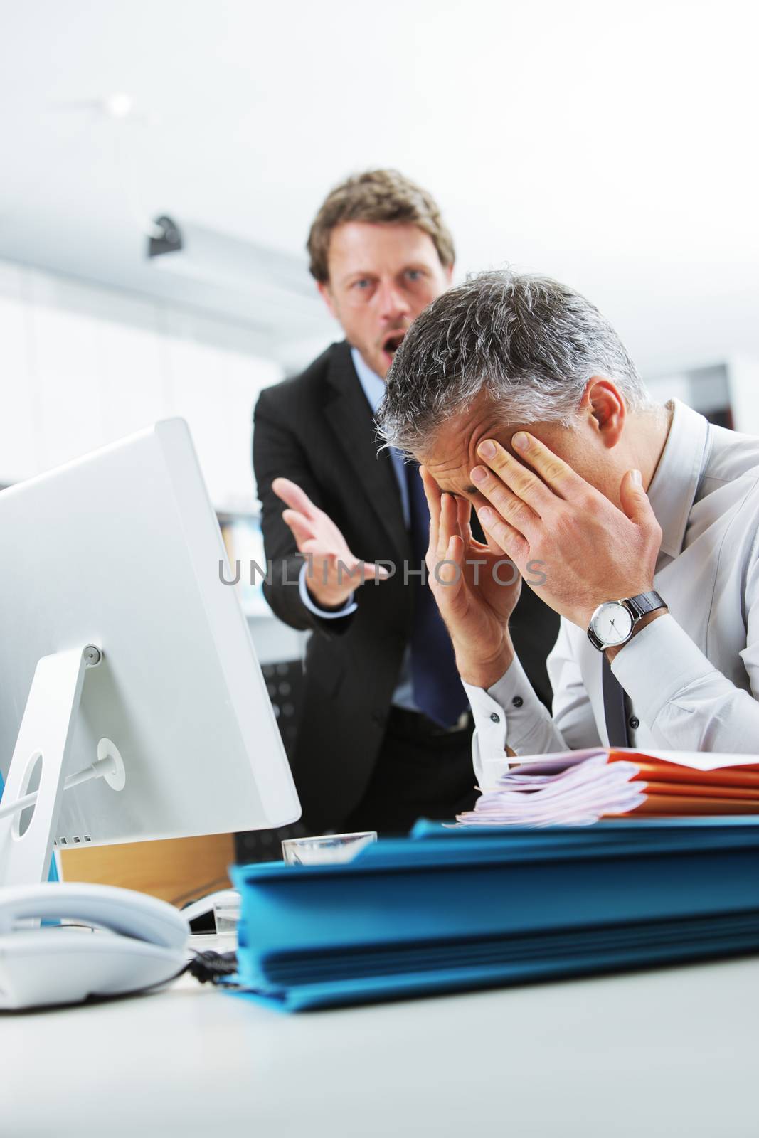 Mature manager shouting at his office worker