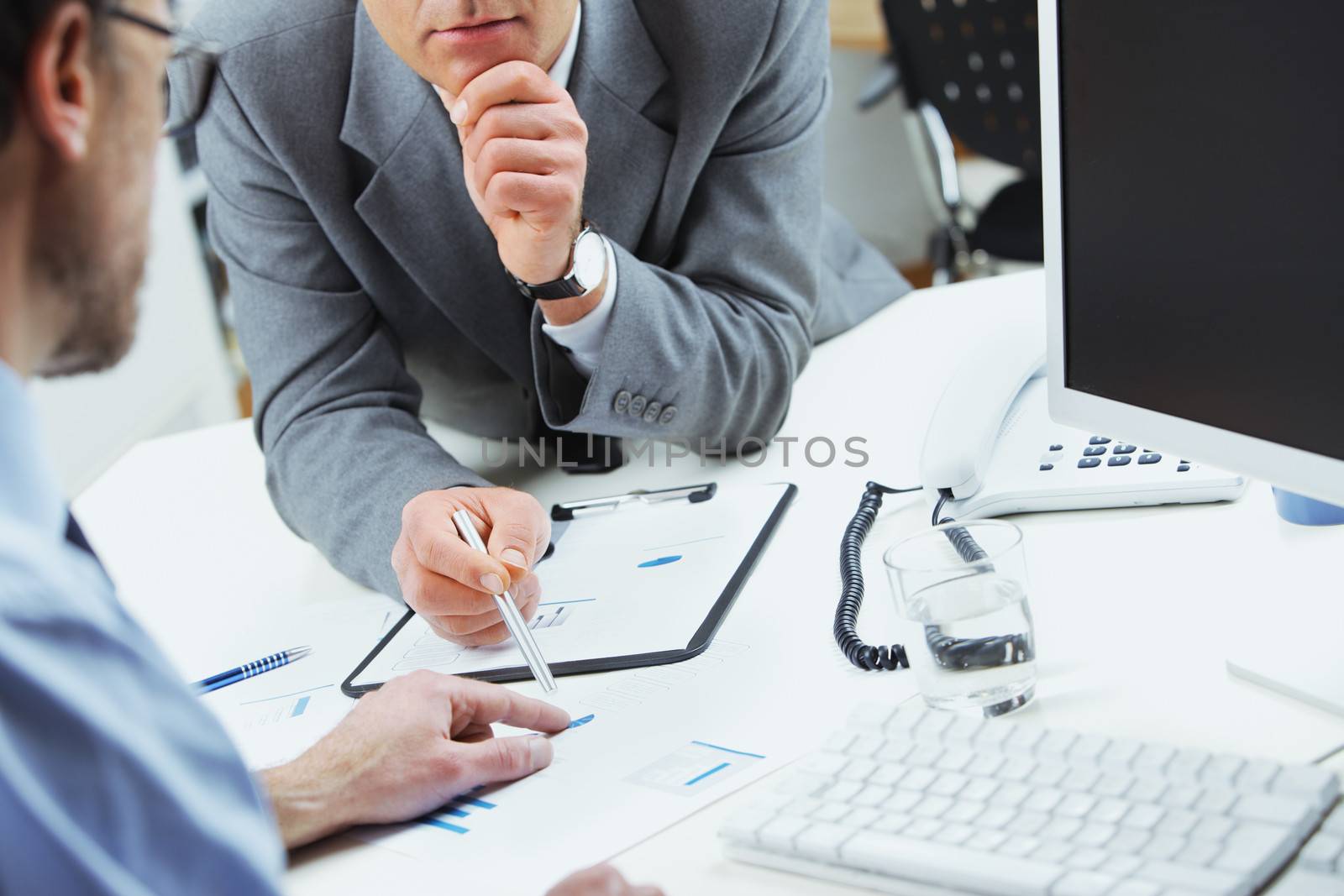 Close up of business colleagues discussing together in an office