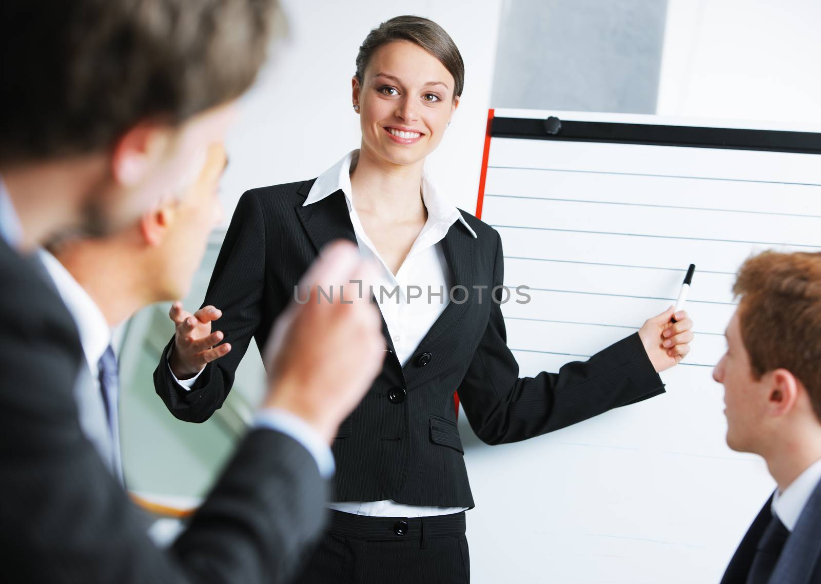 Confident businessowman giving a presentation on whiteboard