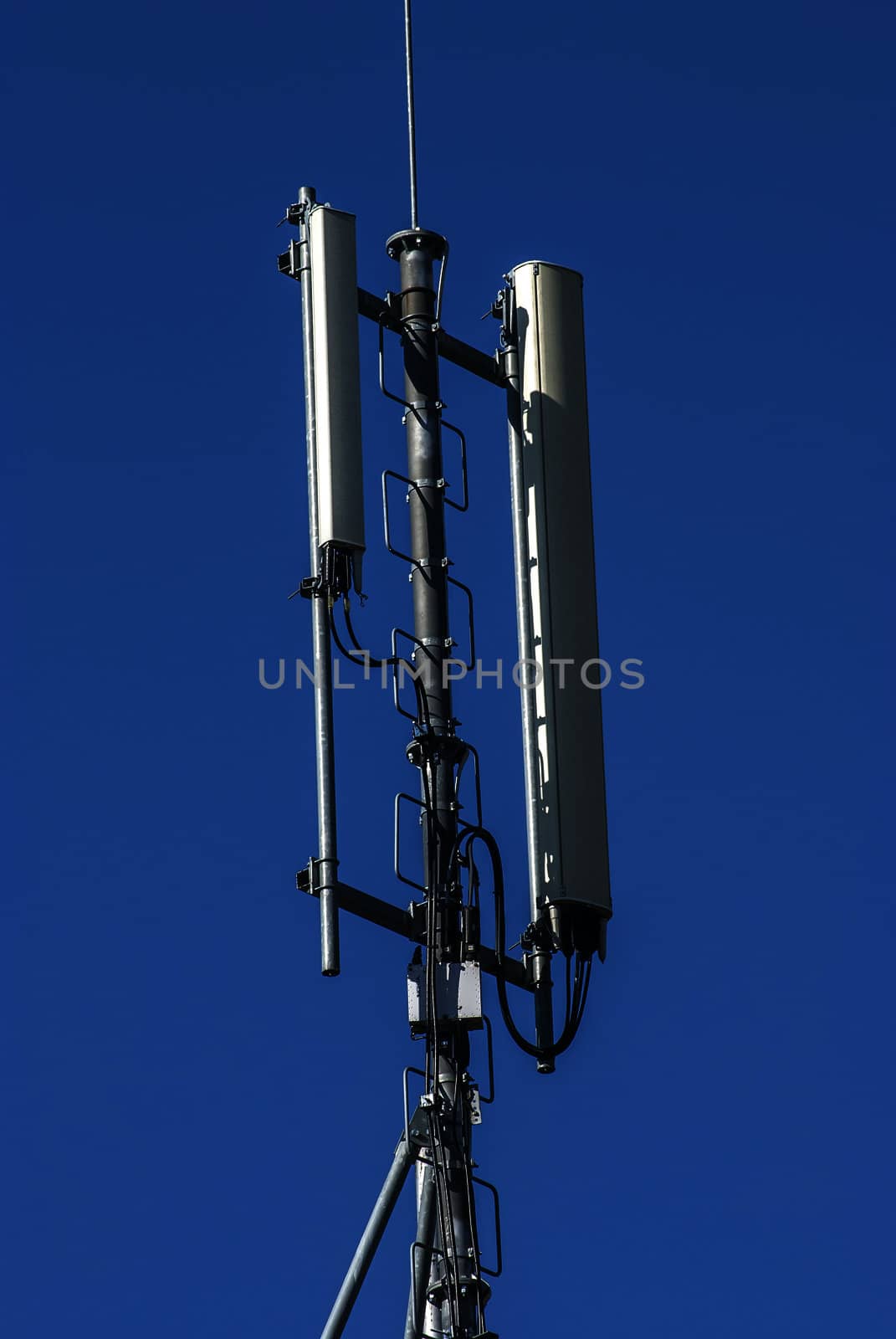 Mobile phone service antenna on blue sky background