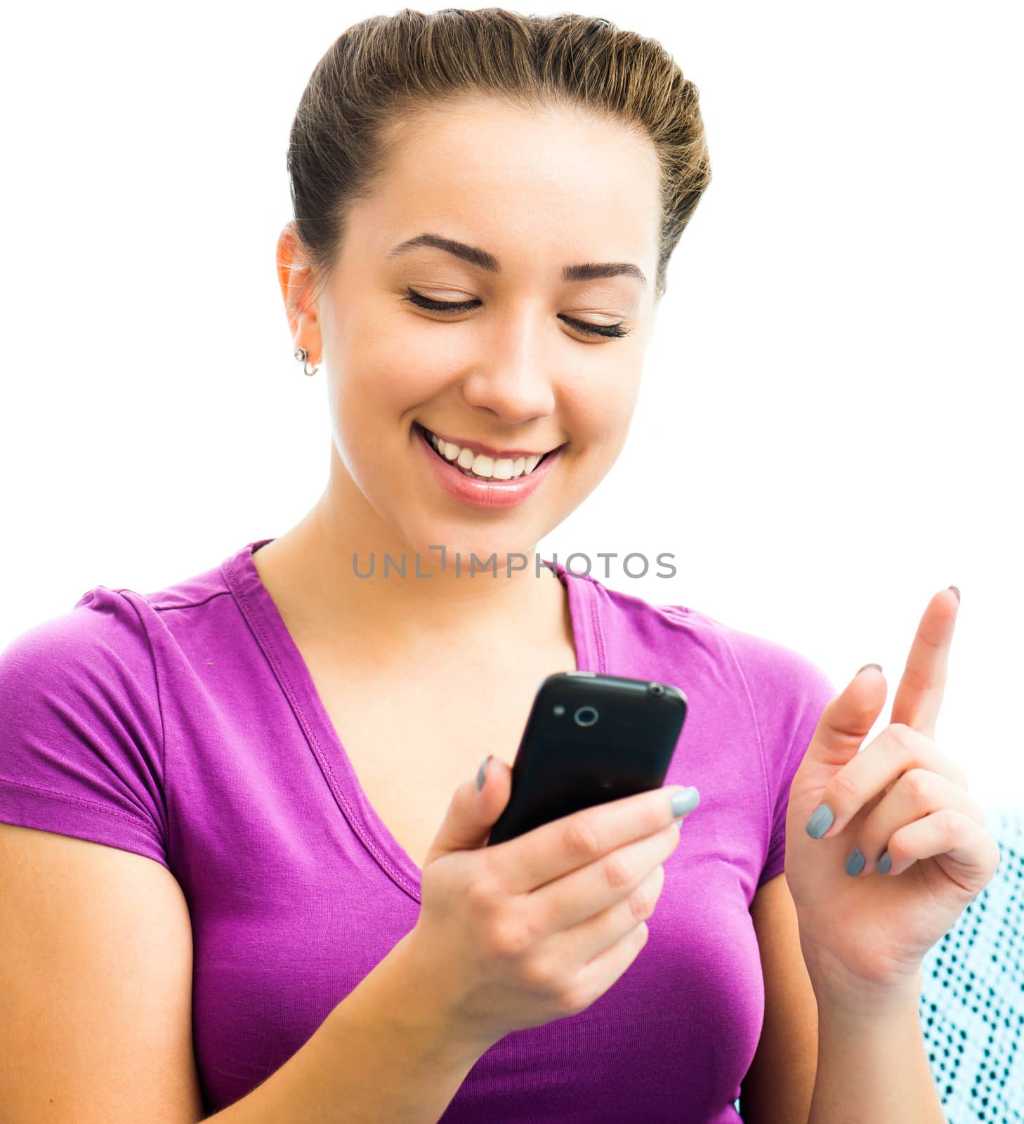 Attractive young brunette woman using her cell phone to send a text message