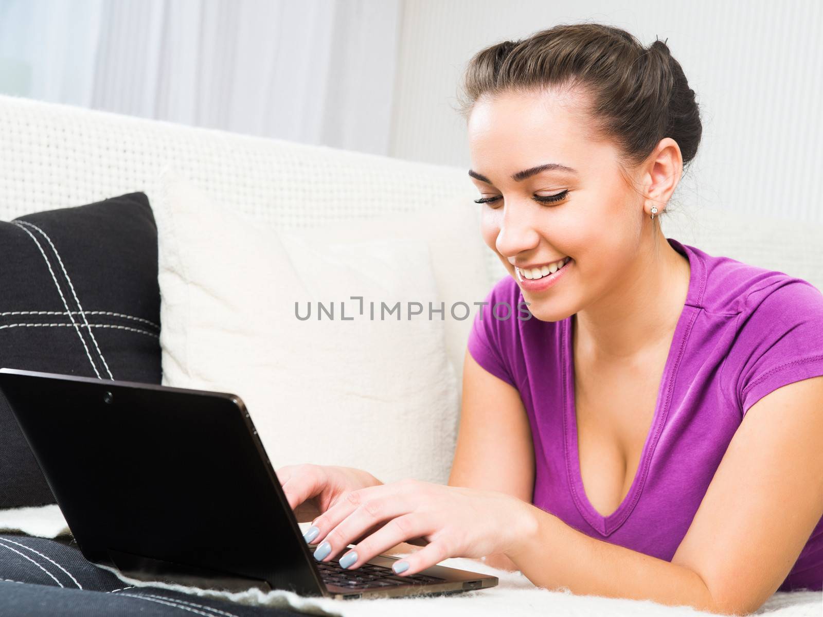 Portrait of an attractive young woman using laptop at home