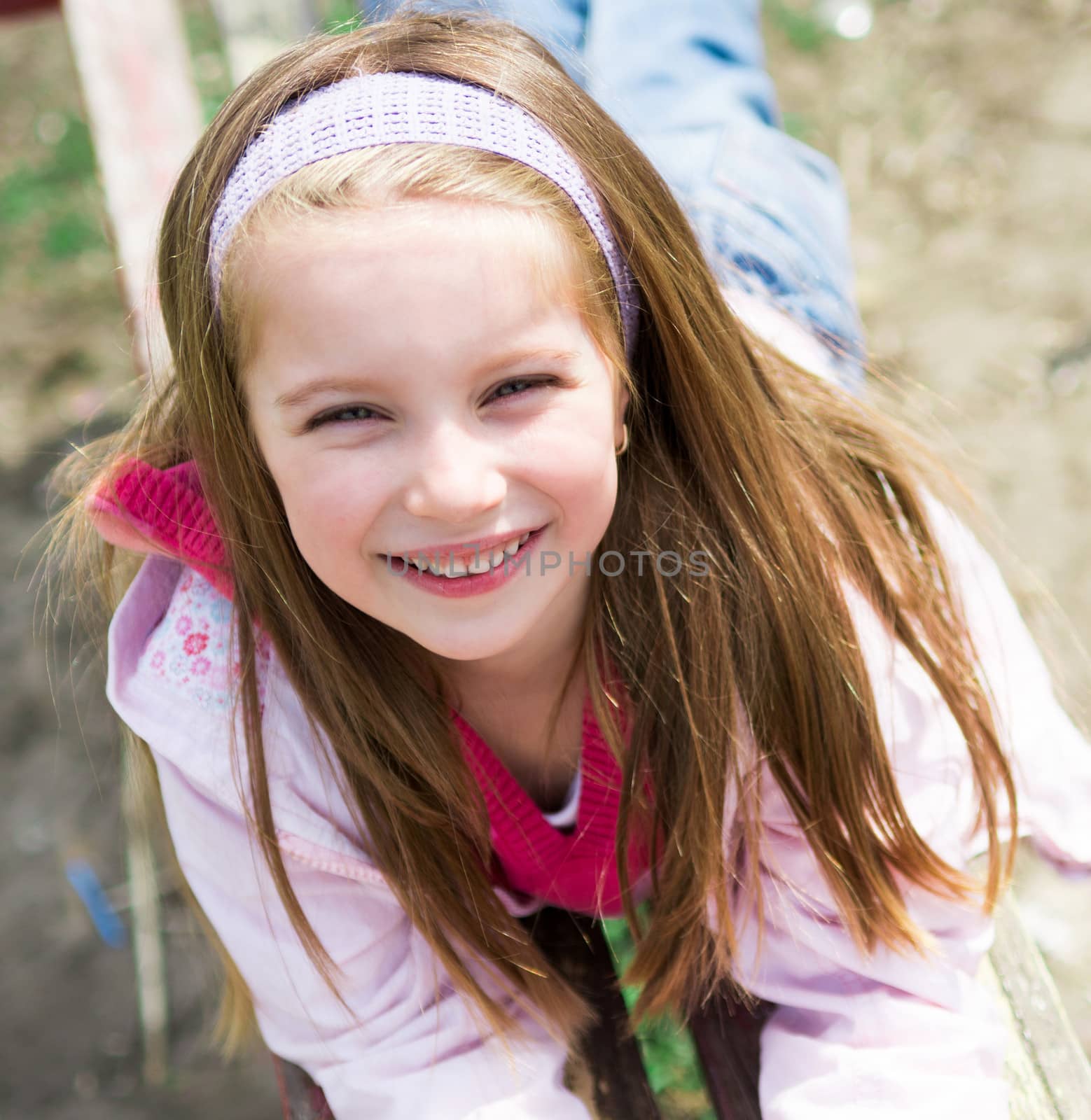 Cute smiling liitle girl in park