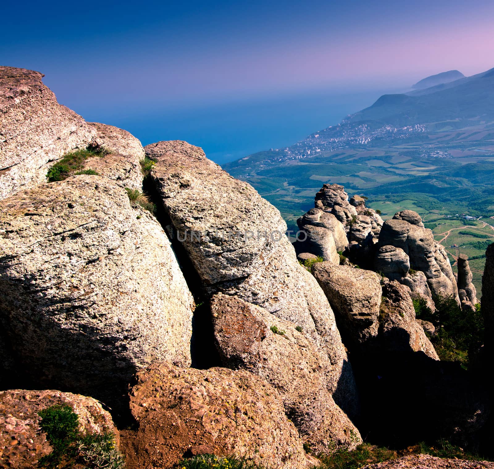 view of the mountains and rocks with violet sky