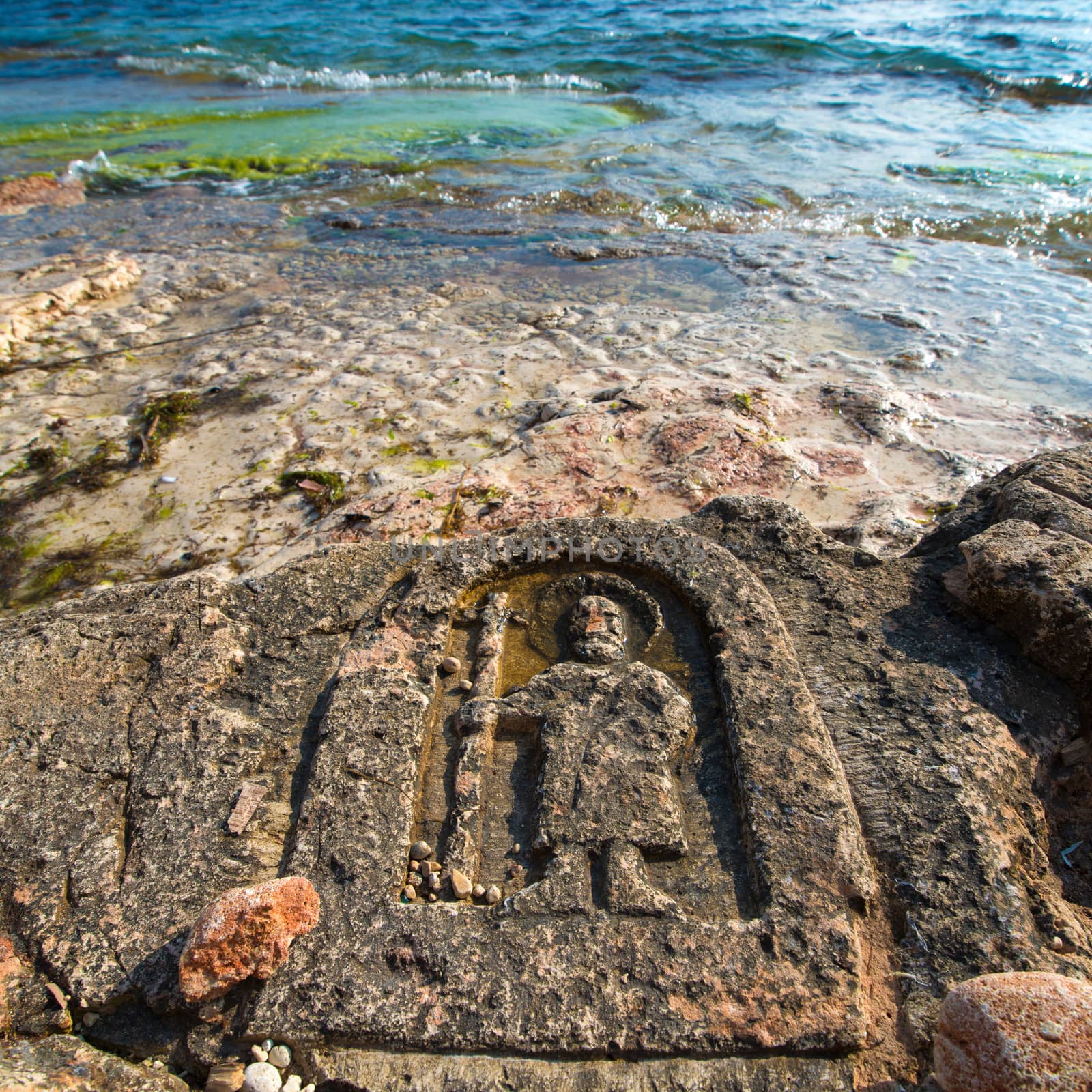 Rock carvings on the beach (icon of the saint with his staff) near Sevastopol (Crimea), Ukraine, May 2013