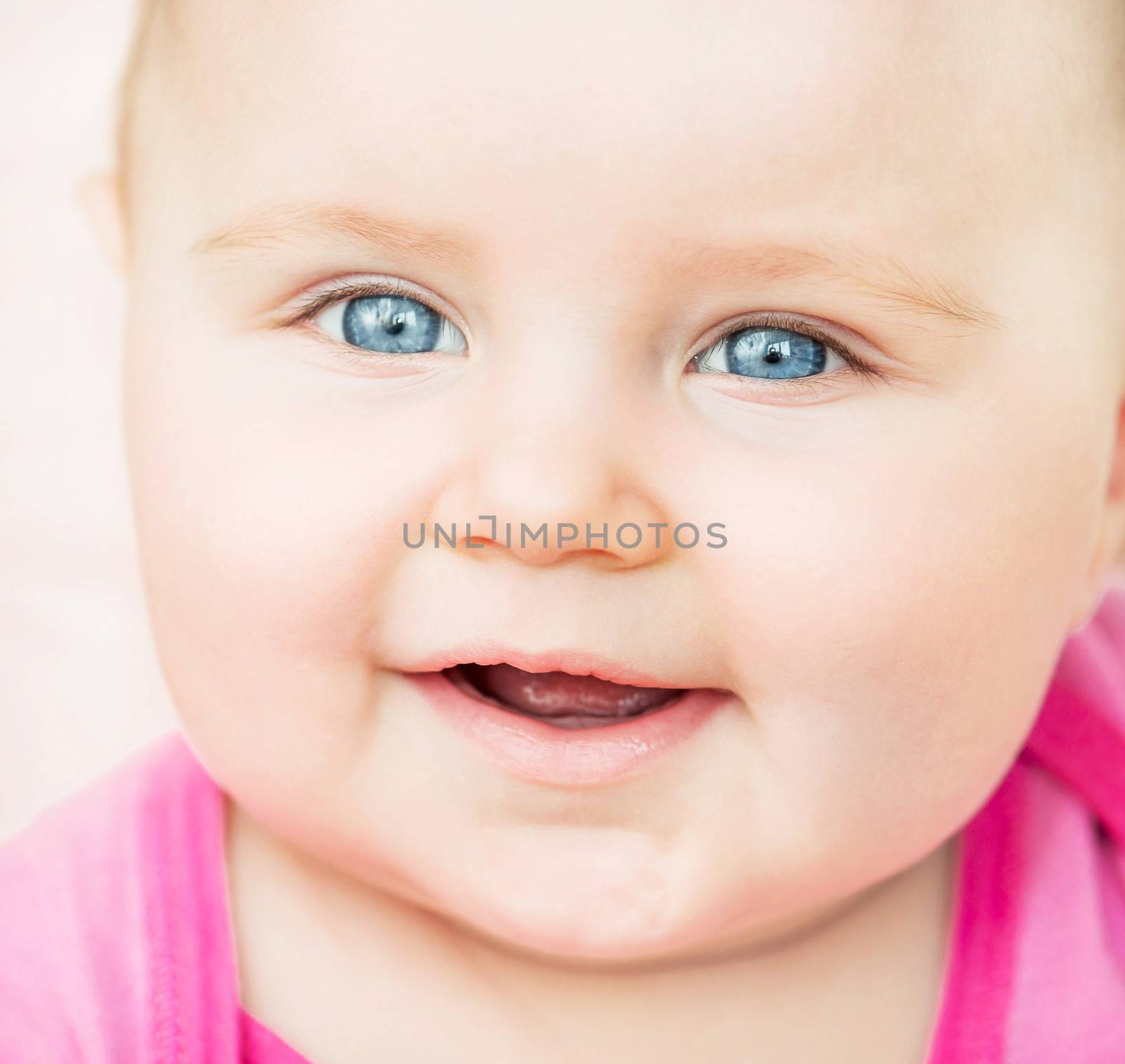 bright closeup portrait of smiling adorable baby