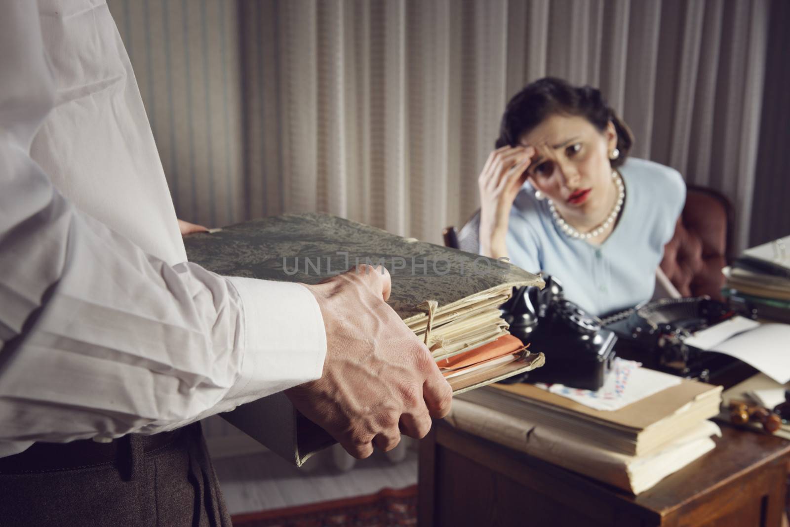 Stressed businesswoman with a too much paperwork and documents