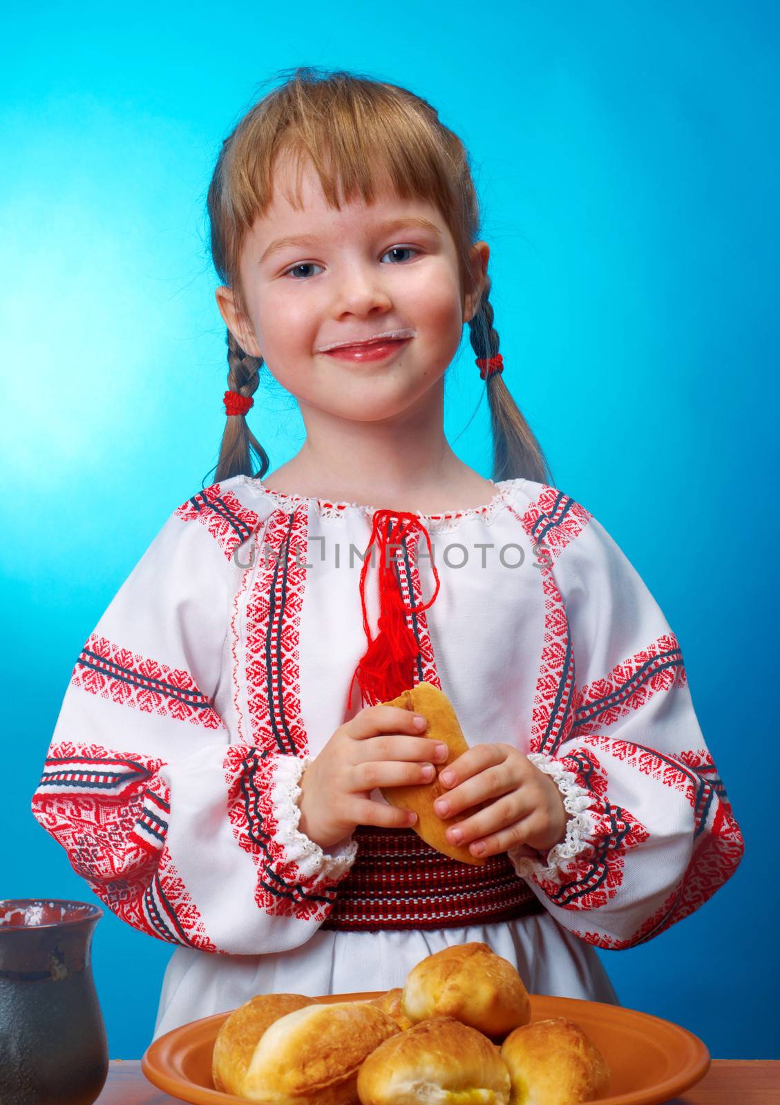 Russian little girl eats homemade pie