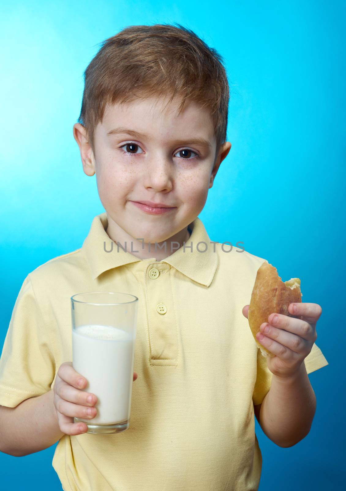  little boy  eats homemade pie and glass of milk