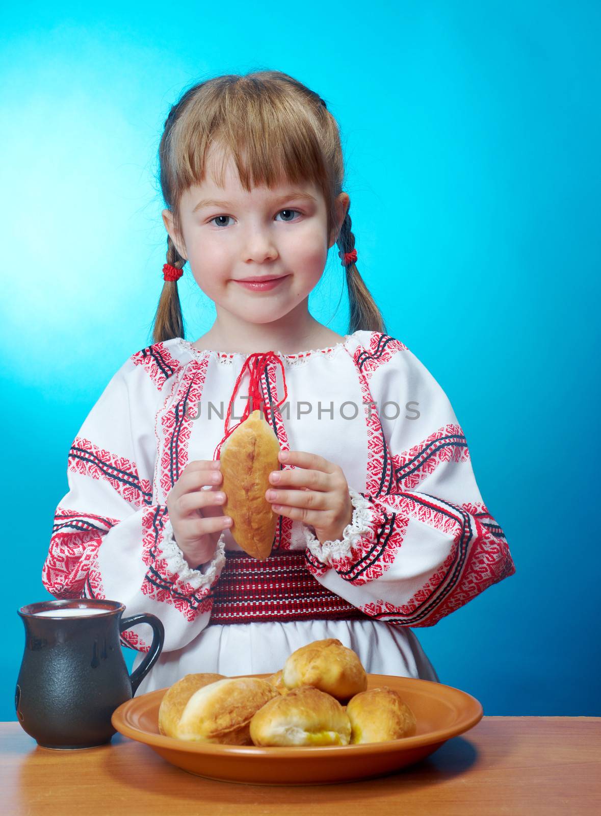 Russian little girl eats homemade pie