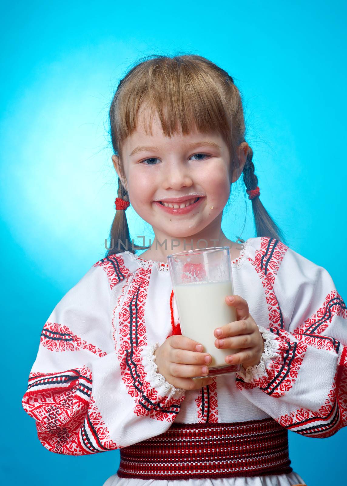 Russian little girl drinking glass of milk