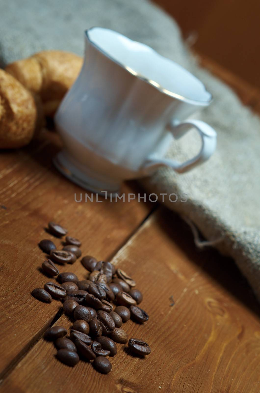 Coffee cup with cinnamon and coffee beans background