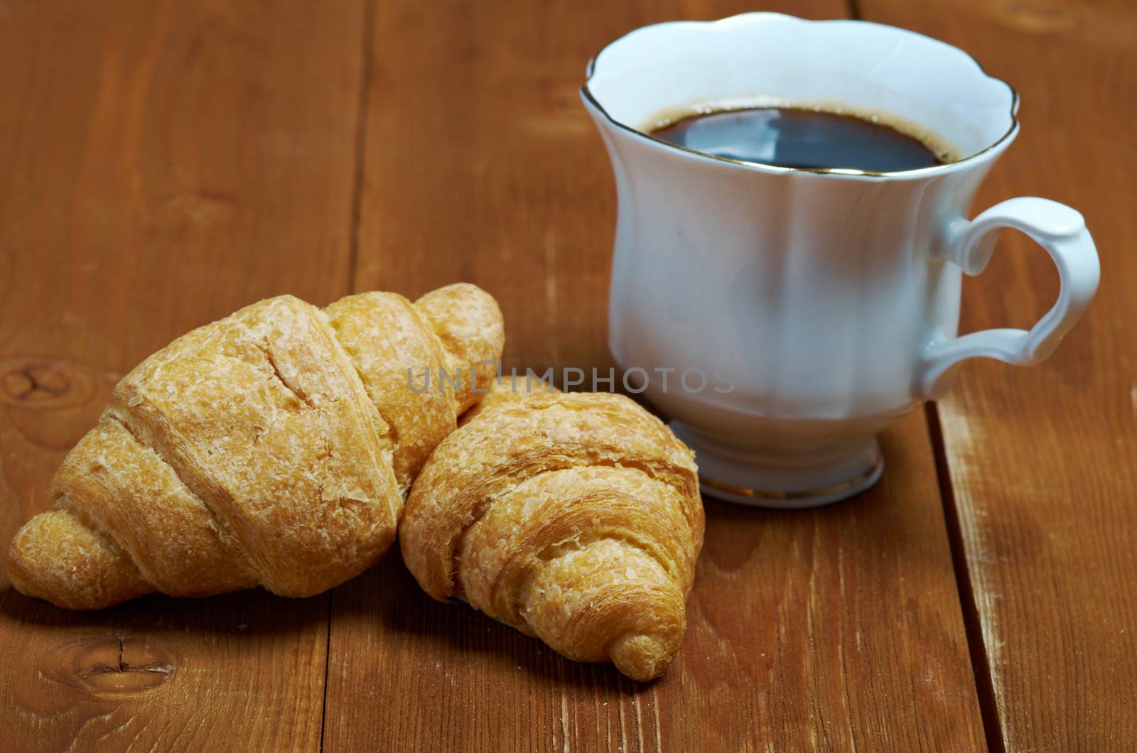 Coffee cup with cinnamon and croissant ,coffee beans background
