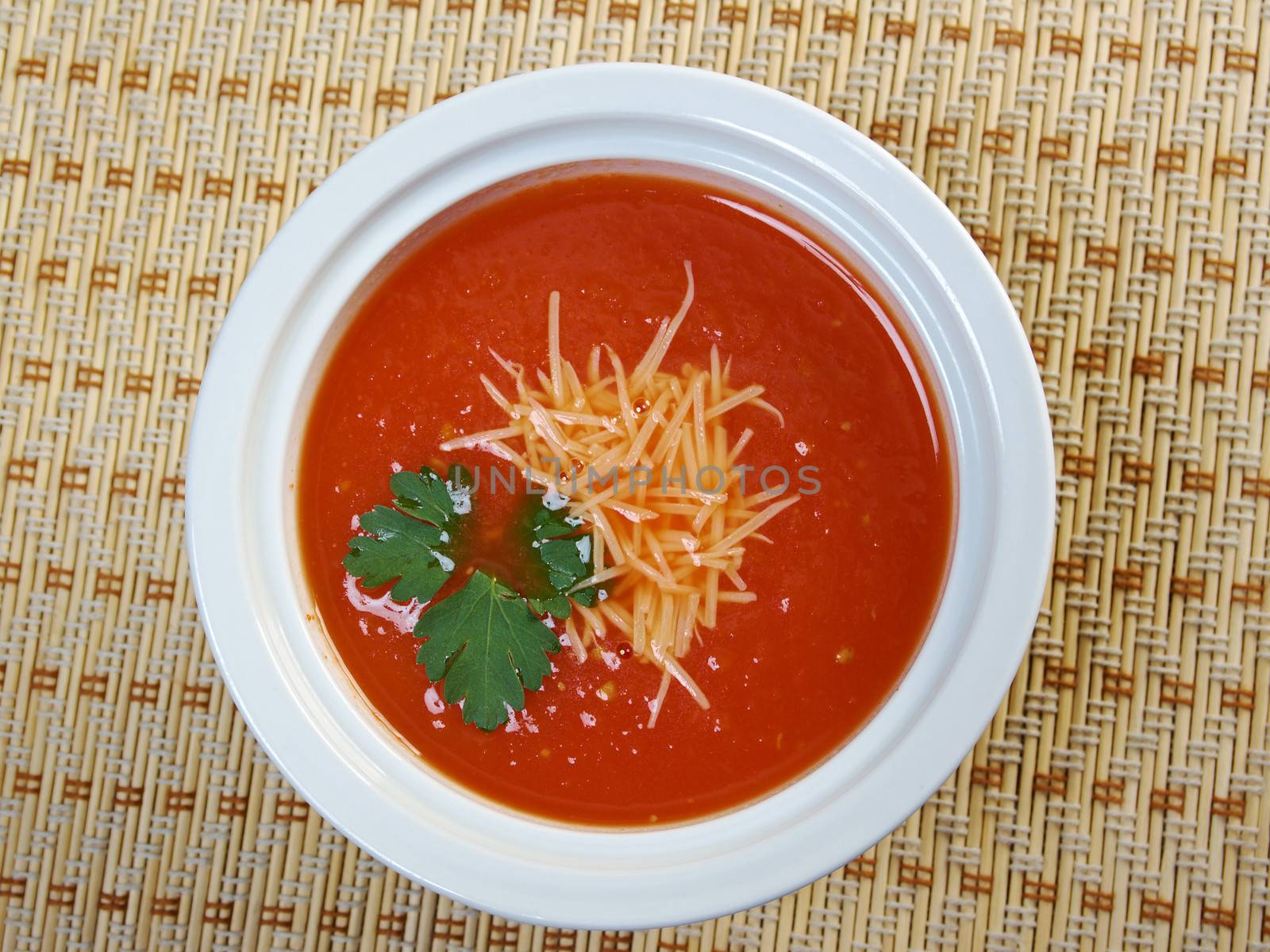 Thick and hearty tomato soup with basil.closeup