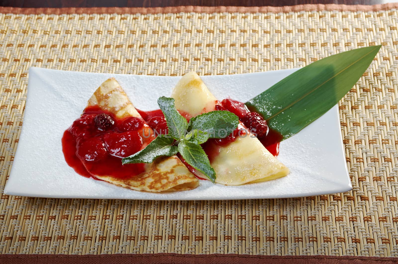 Pancakes with strawberry jam.closeup