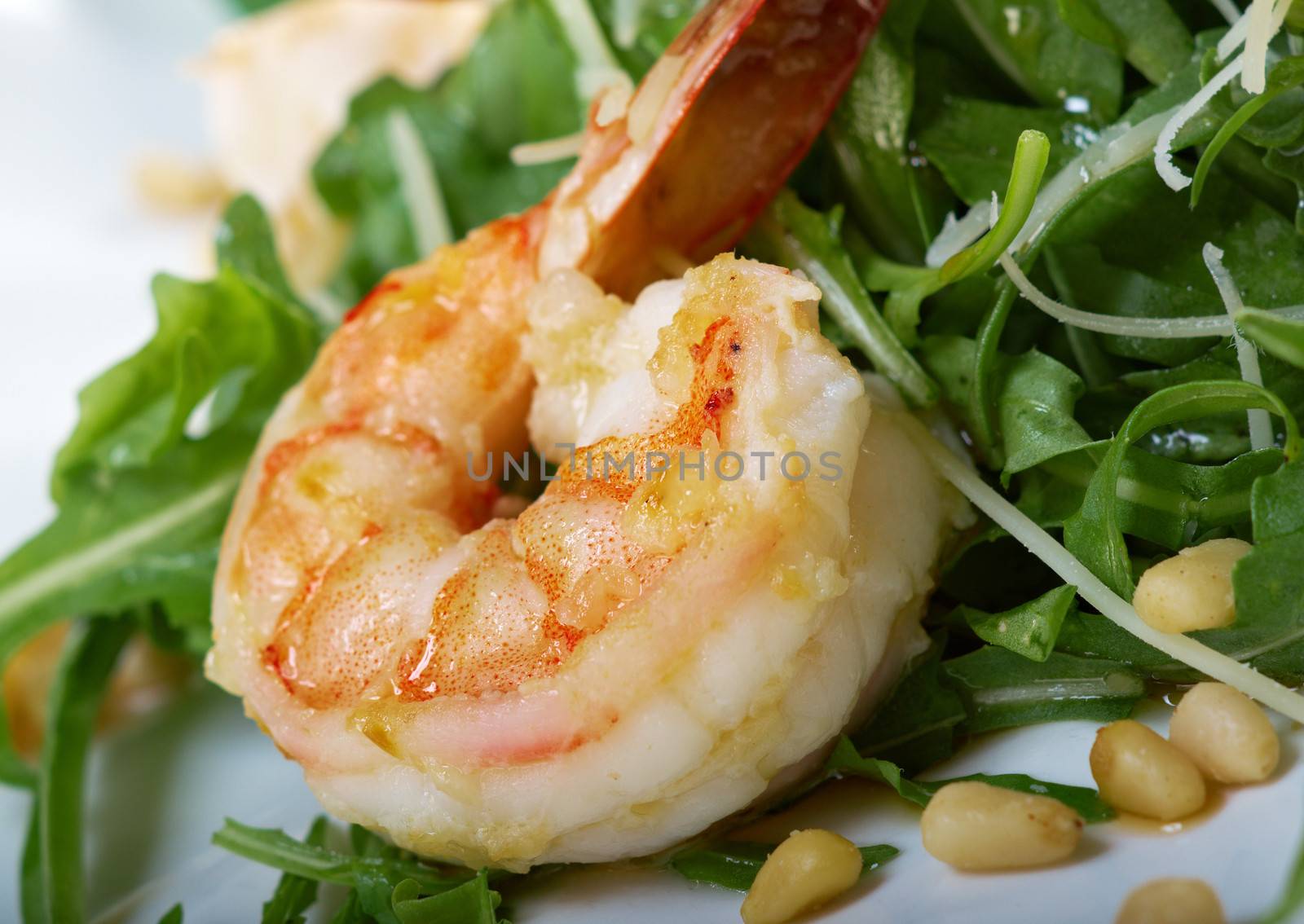 arugula salad with prawn on plate closeup