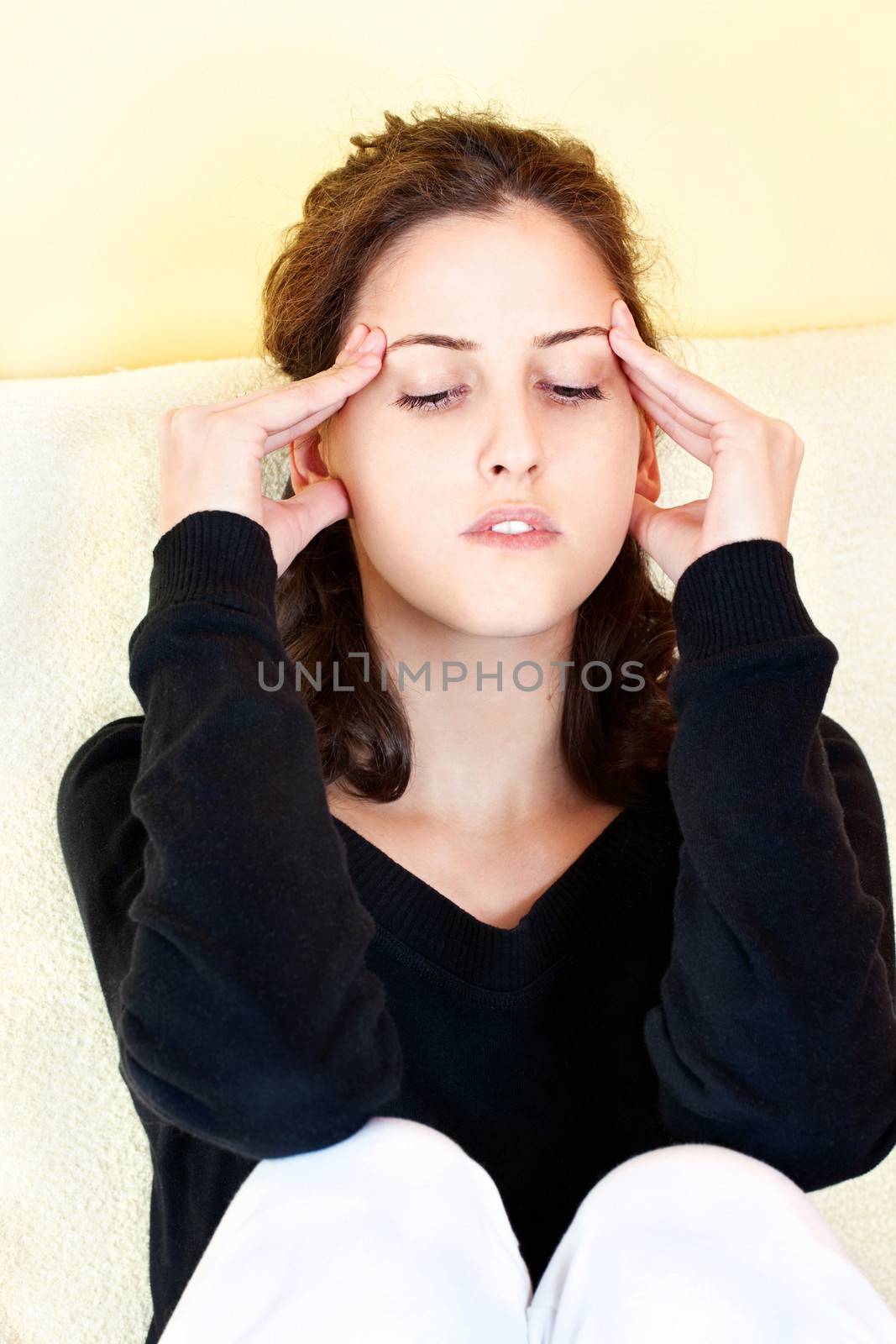 Young woman having headache at home