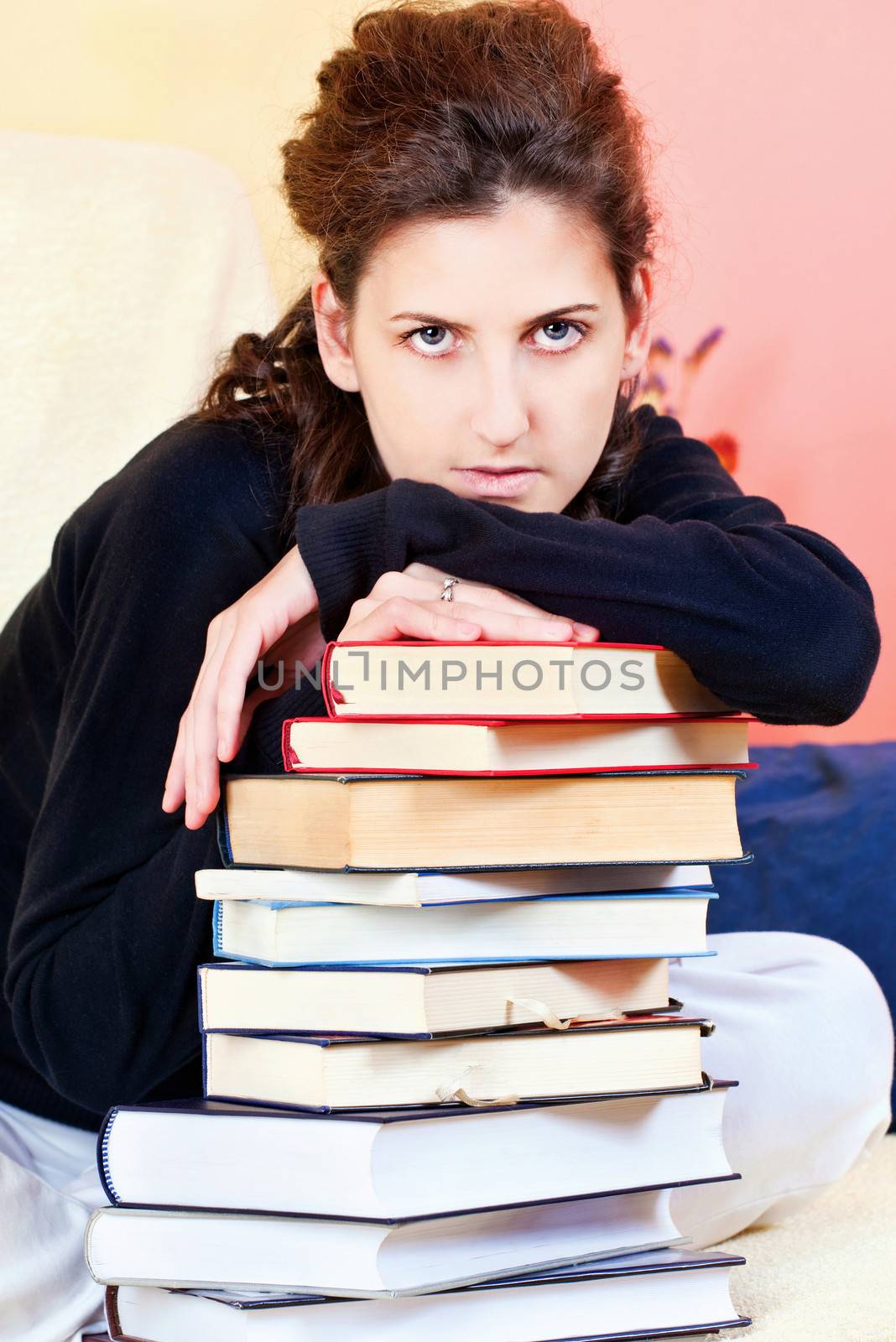 Female student and bunch of books at home