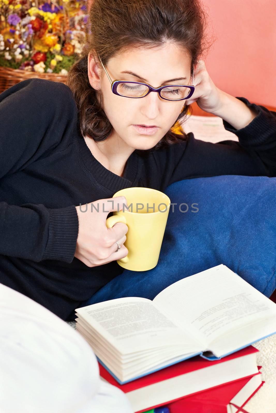 Young woman reading book at home