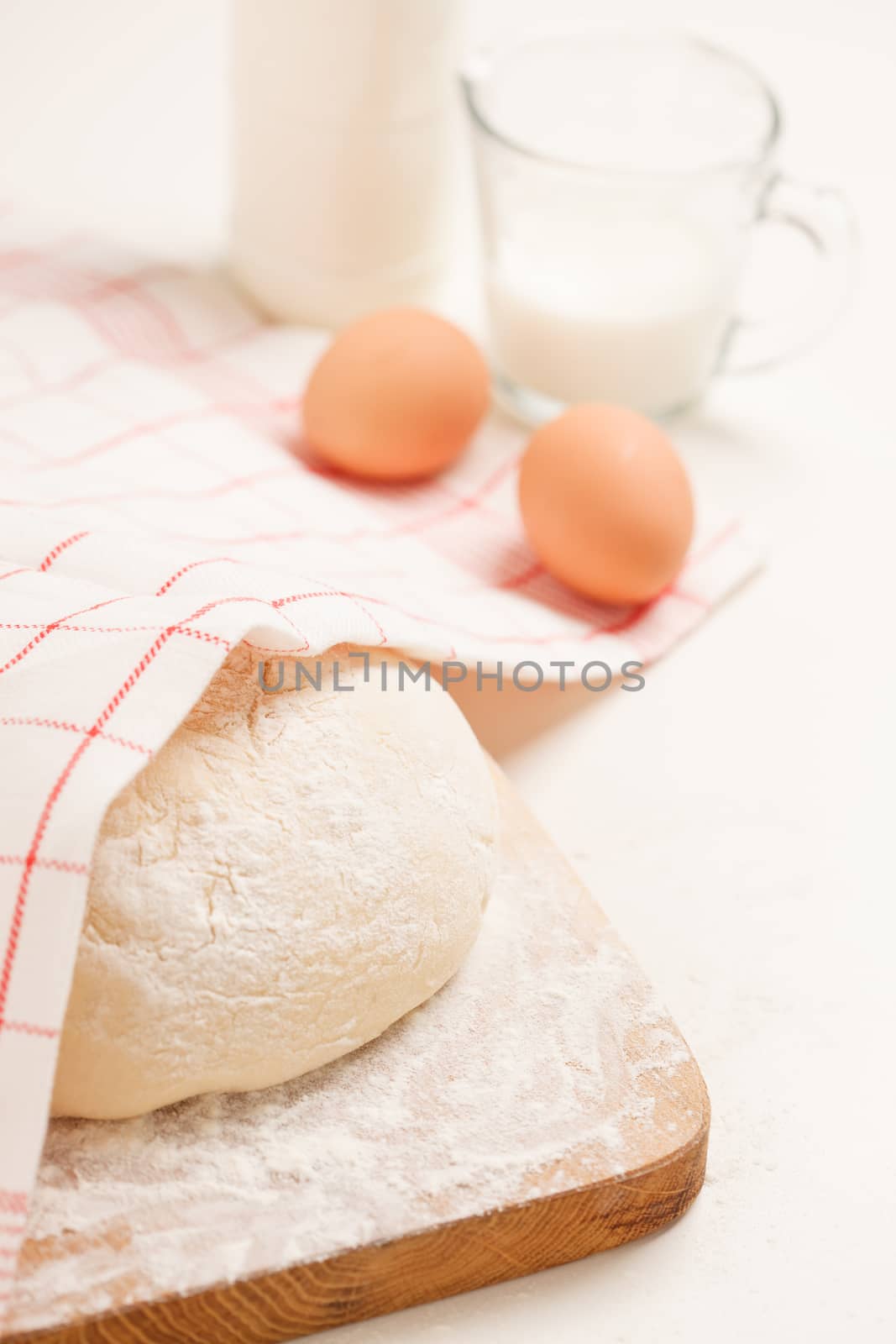 Dough on wooden board by shebeko