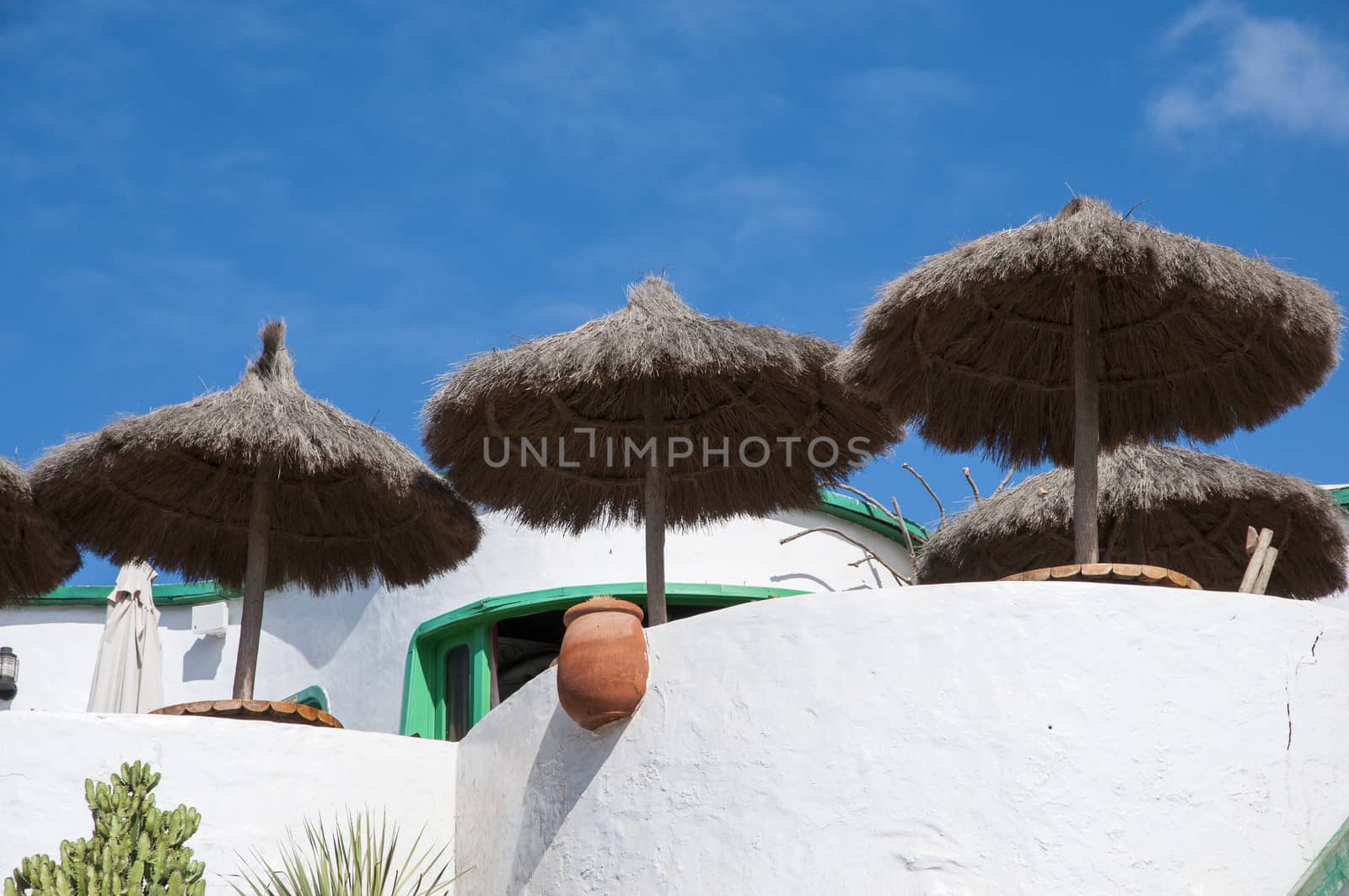 white colored houses with umbrella on top of the mountain