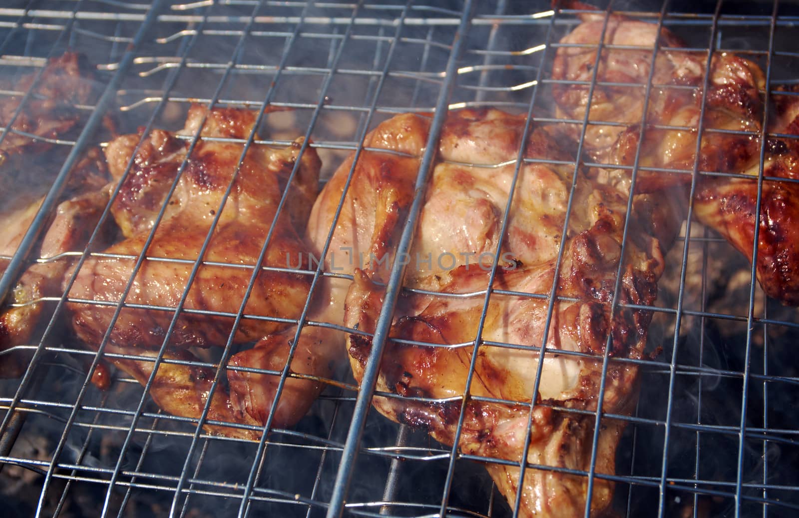 barbecue.chicken on the grill with flames