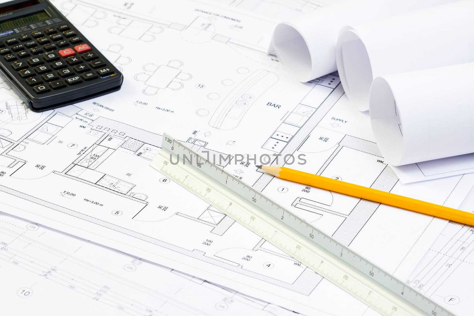 Blueprint of architecture, calculator, pencil and scale ruler