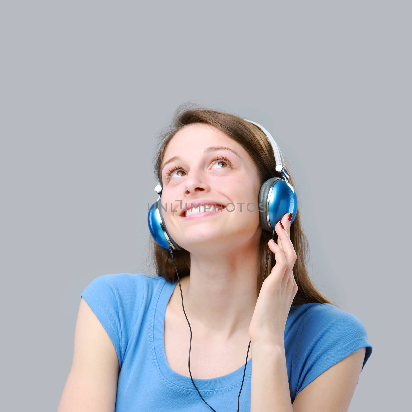 Beautiful girl listening to music on headphones