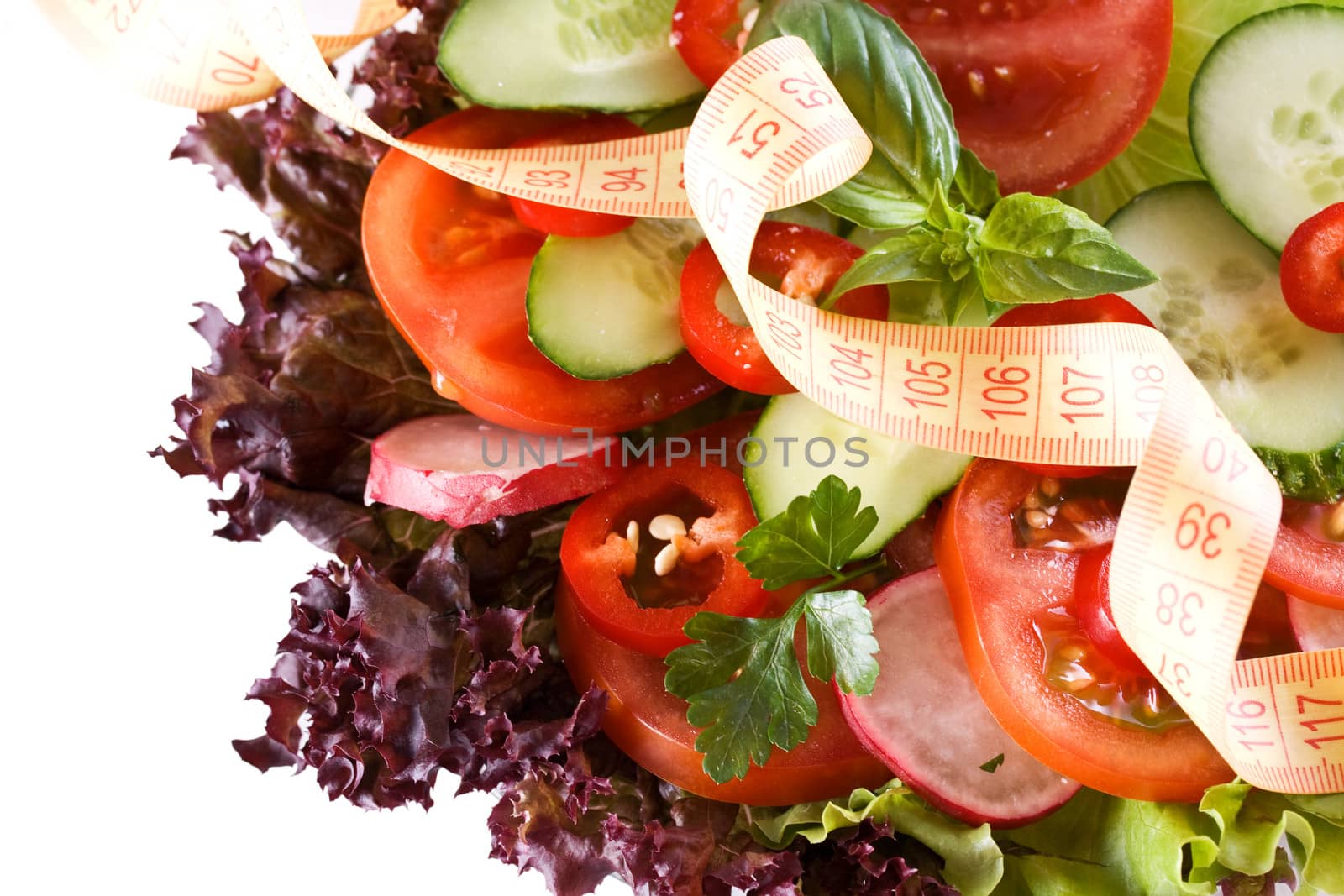 Conceptual assorted salad and tape measurement, close up